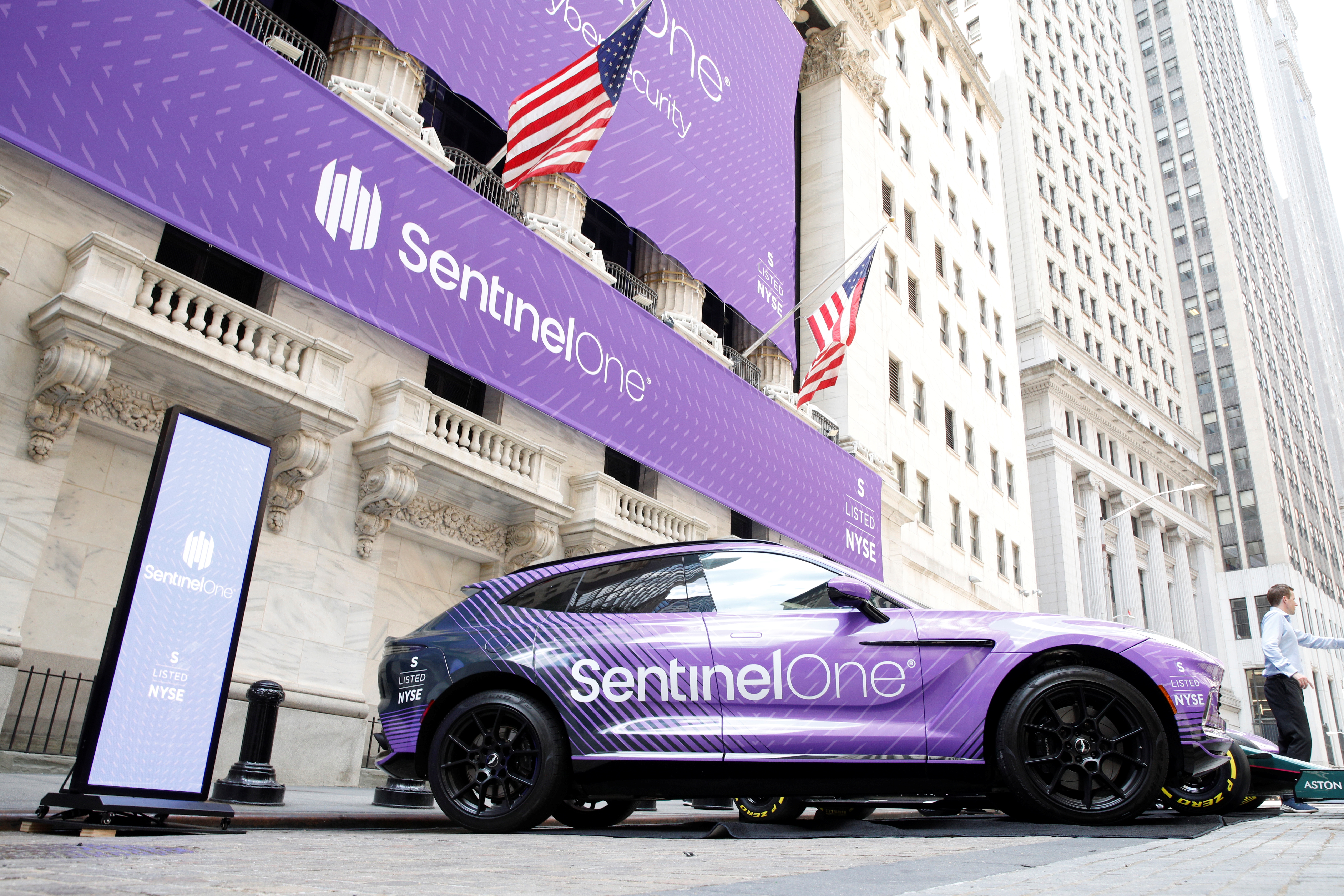 Signage and cars are displayed in honor of SentinelOne, a cybersecurity firm’s IPO, outside the NYSE in New York