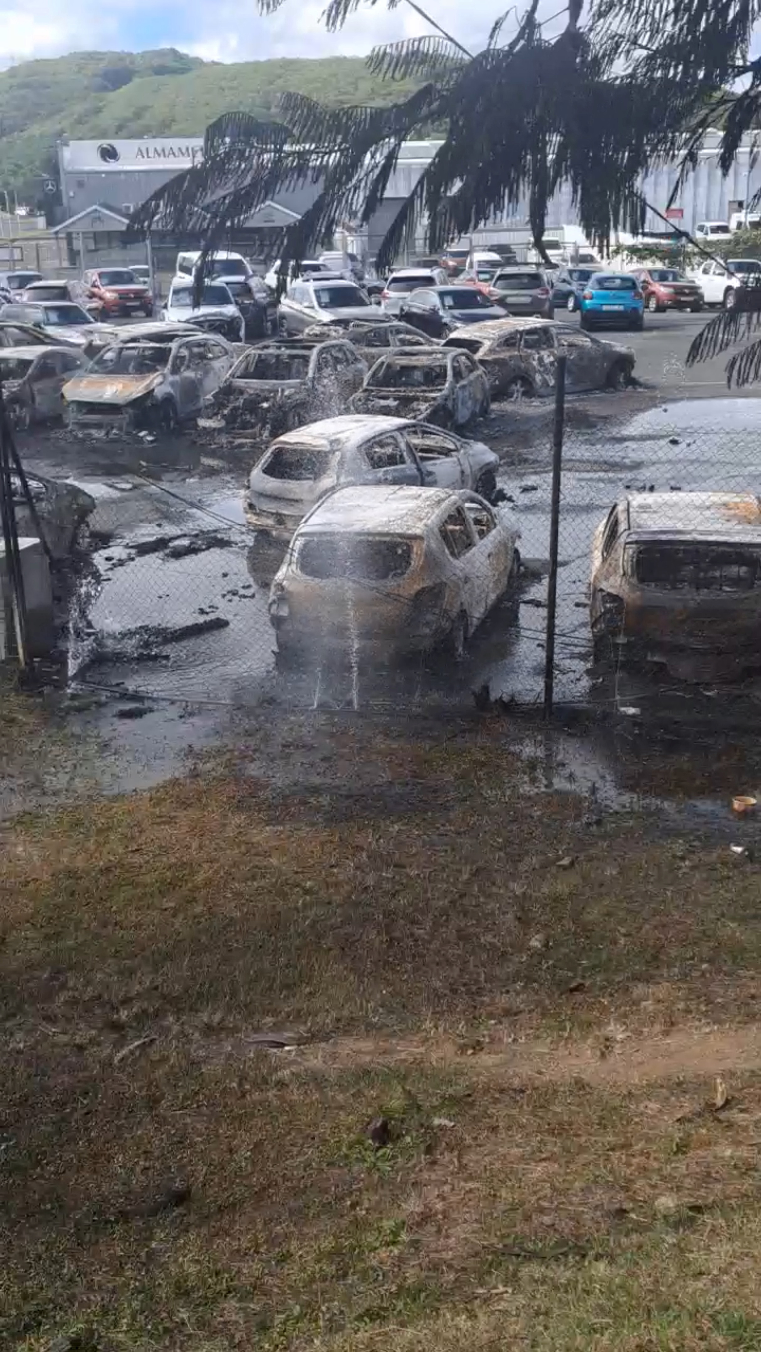 Burnt cars in the aftermath of protests that turned violent, in Noumea