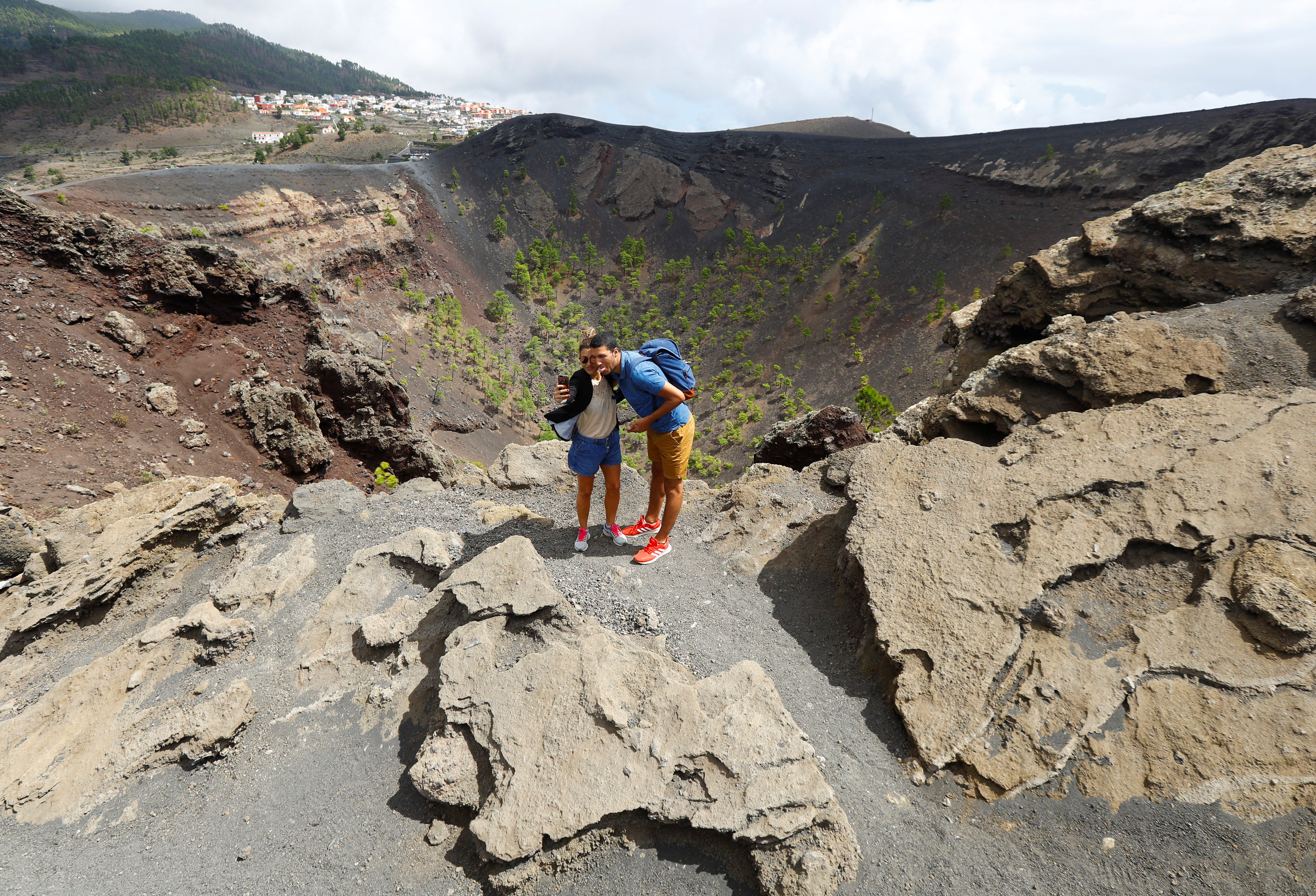 Tourists take a selfie at the San Antonio Volcano on the Canary Island of La Palma