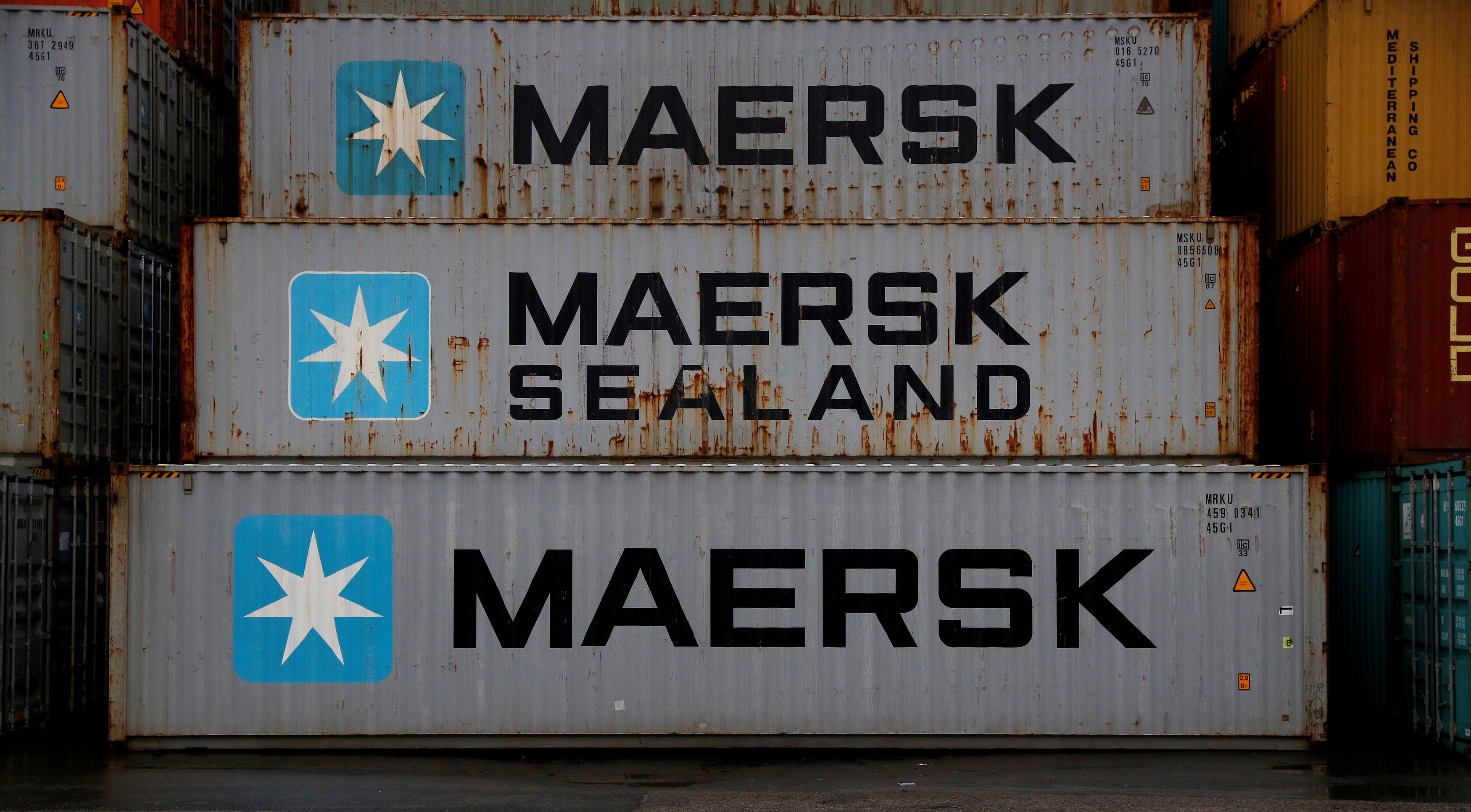 Empty Maersk shipping containers are seen stacked at Peel Ports container terminal in Liverpool