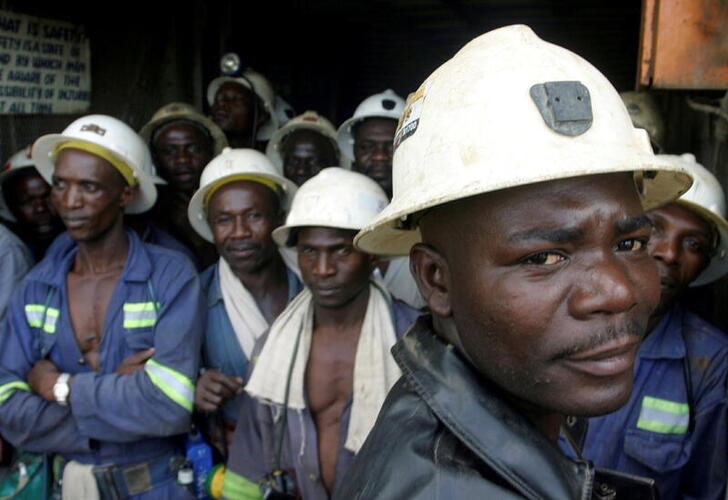 Copper mine workers wait in a lift before going to work underground in Zambia, April 12, 2005. REUTERS/Stringer/File Photo