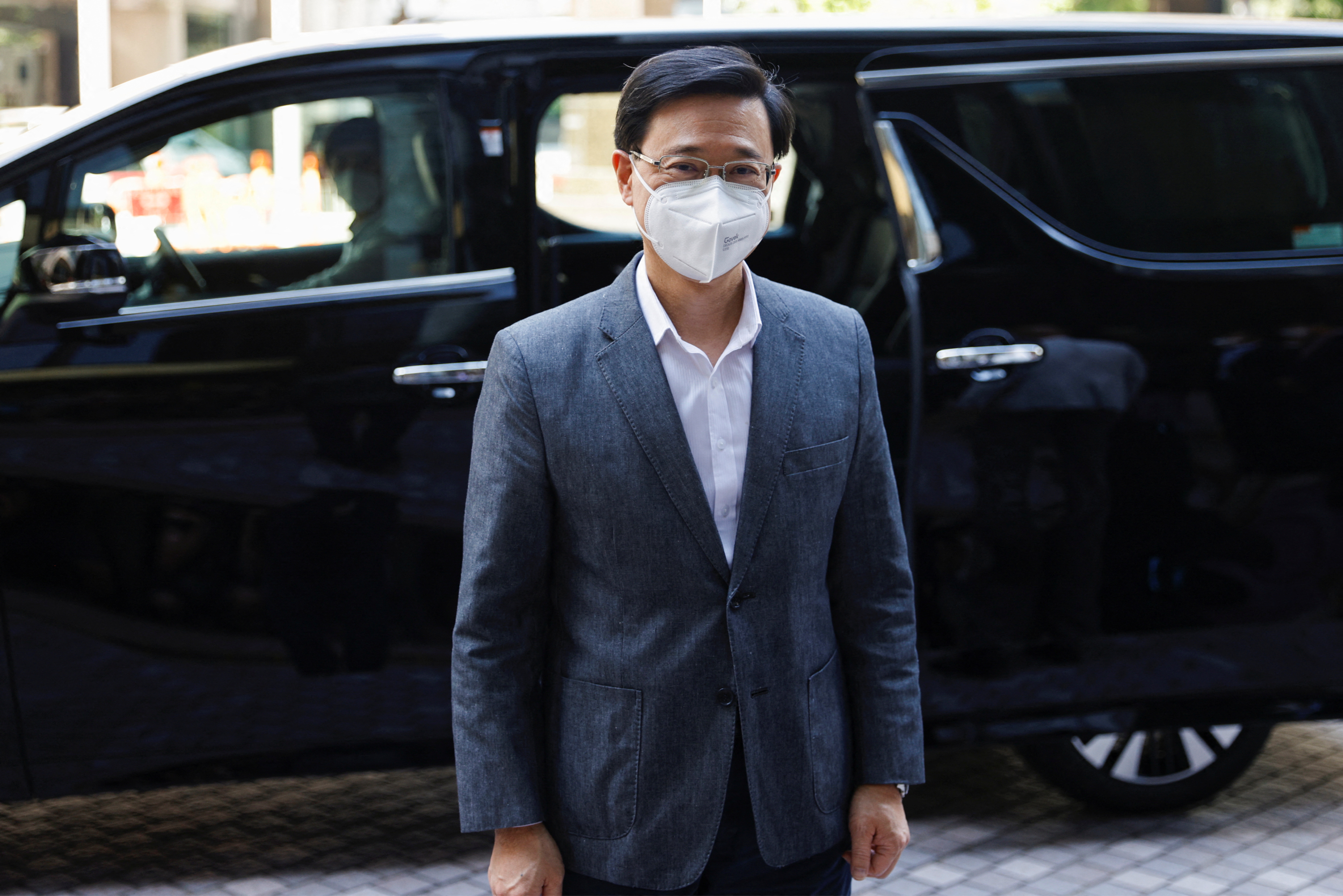 Former Hong Kong Chief Secretary for Administration John Lee, arrives at his office after Central People's Government approves his resignation, in Hong Kong