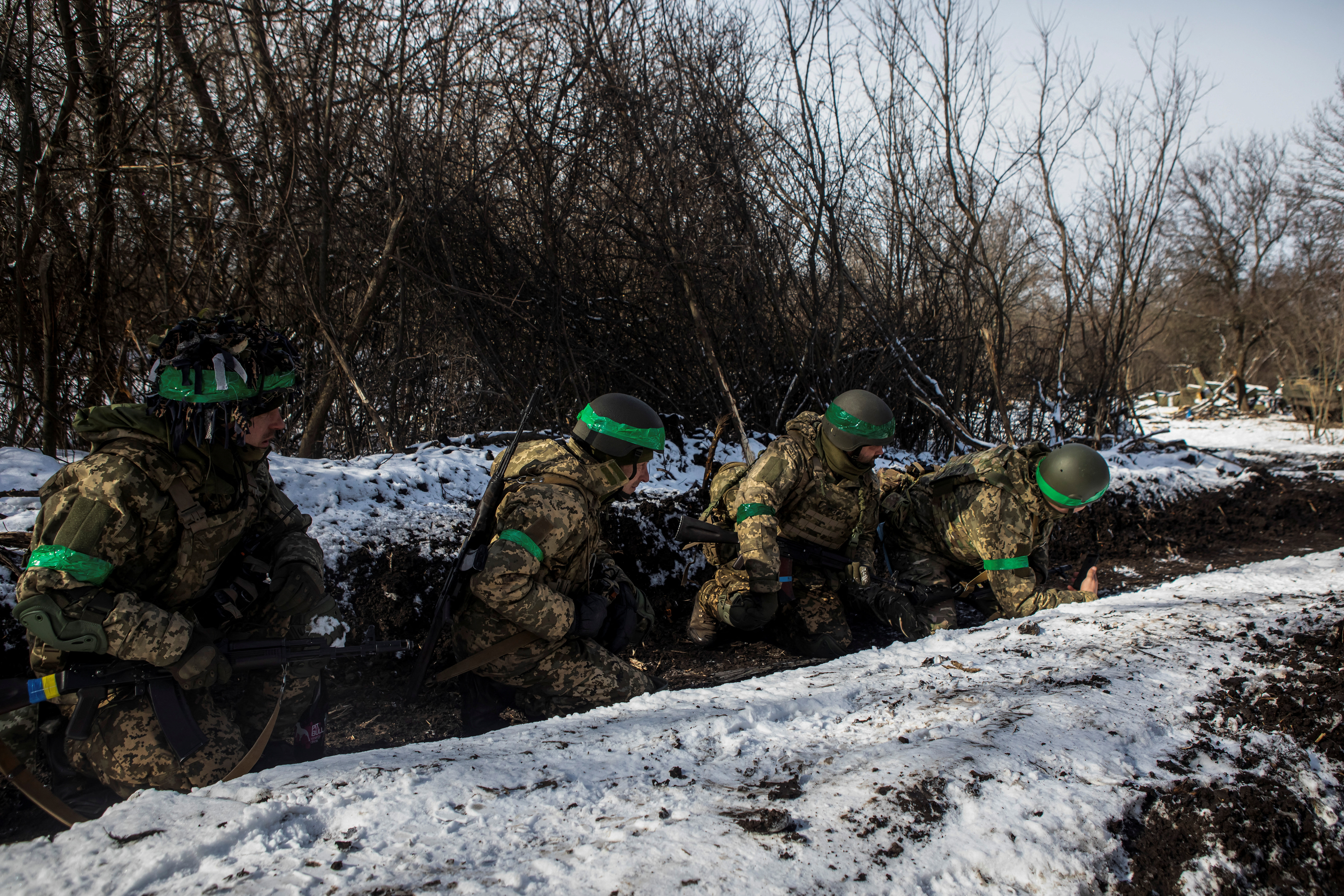 Ukrainian servicemen take cover during a shelling outside the frontline town of Bakhmut