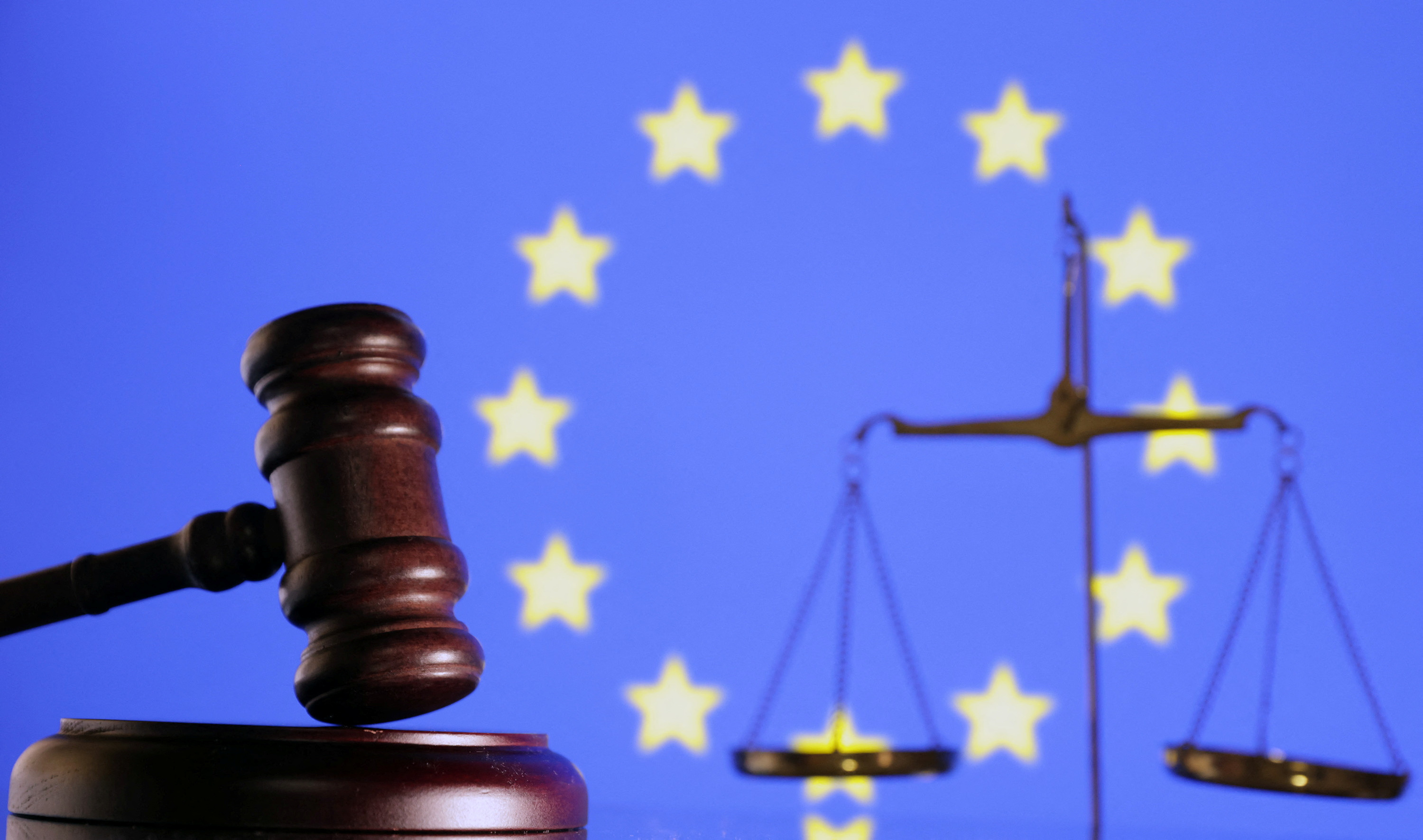 Illustration shows the EU flag, a judge gavel and a vintage scale