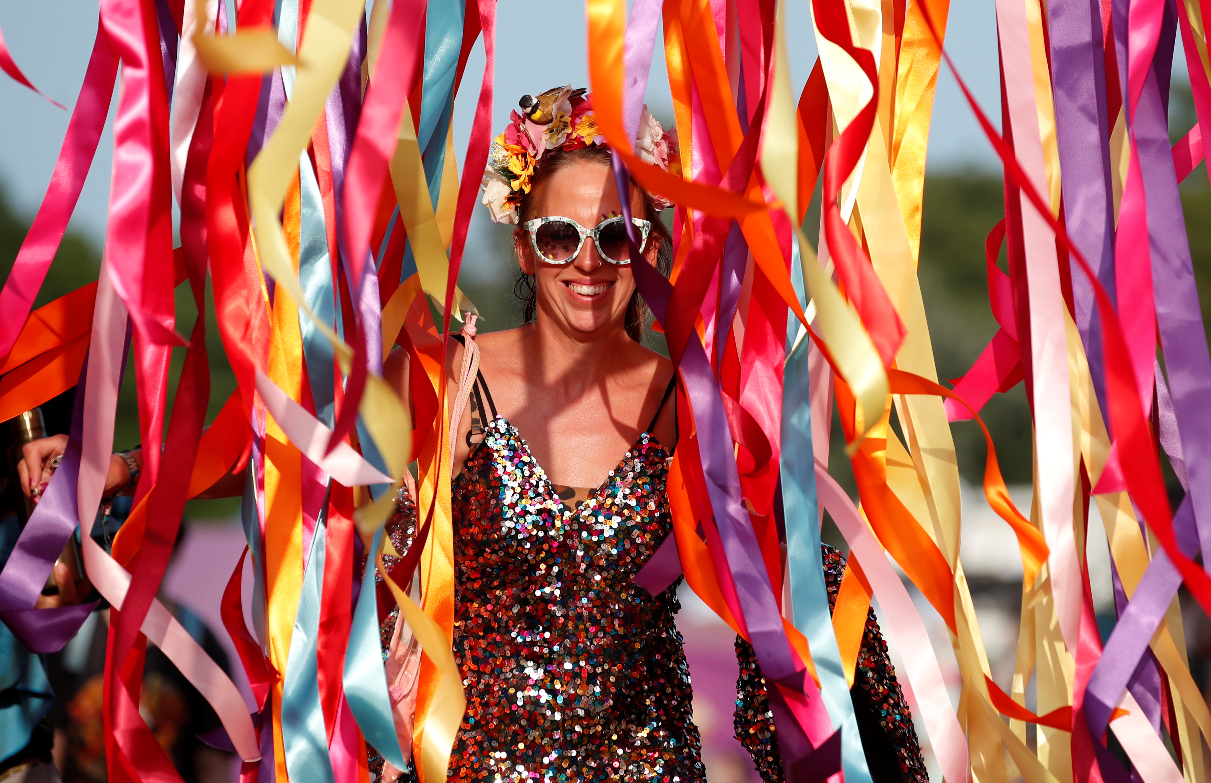 A festivalgoer walks through ribbons at Latitude Festival at Henham Park
