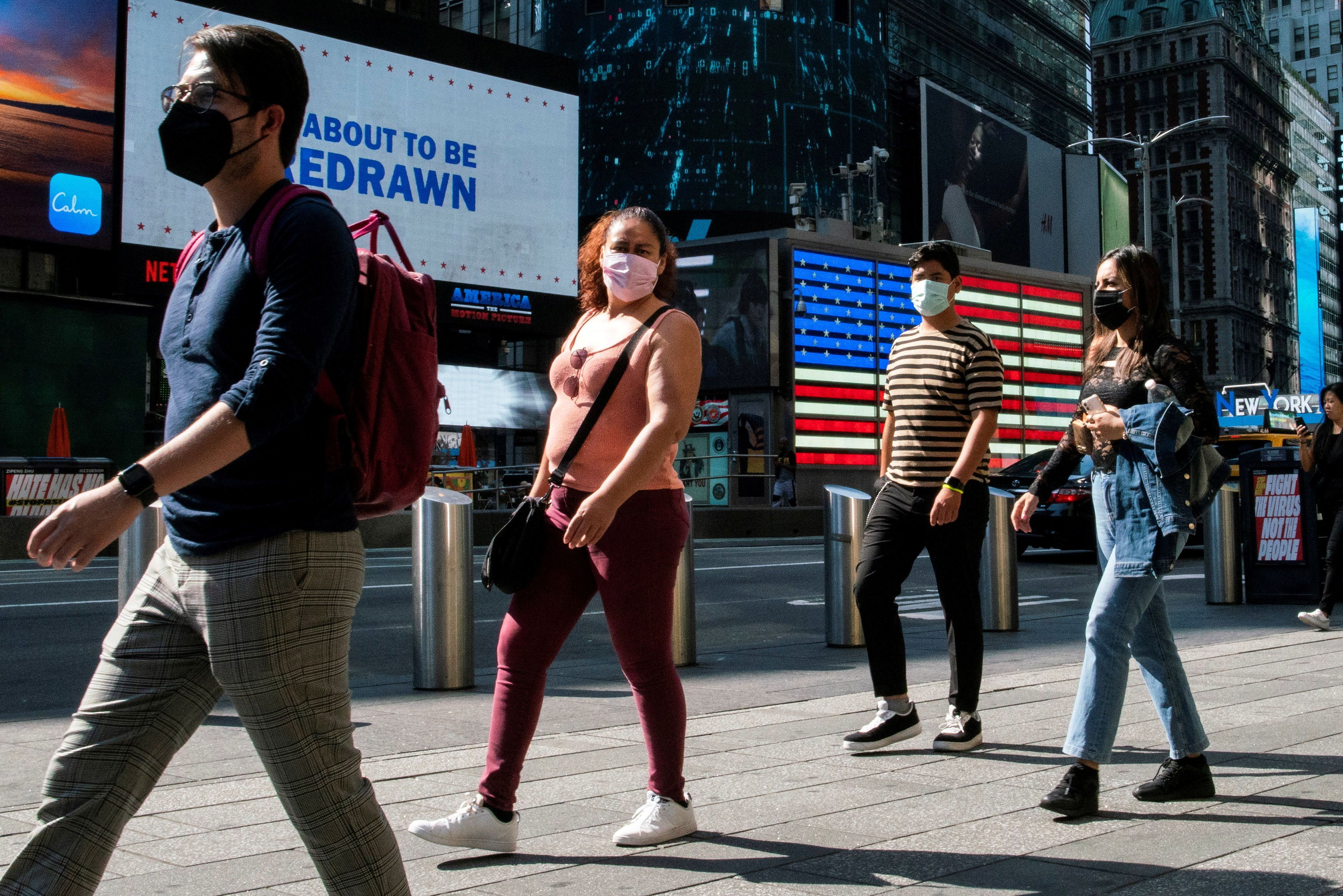 People wear masks around Times Square, as cases of the infectious coronavirus Delta variant continue to rise in New York City, New York, U.S., July 23, 2021. REUTERS/Eduardo Munoz/File Photo