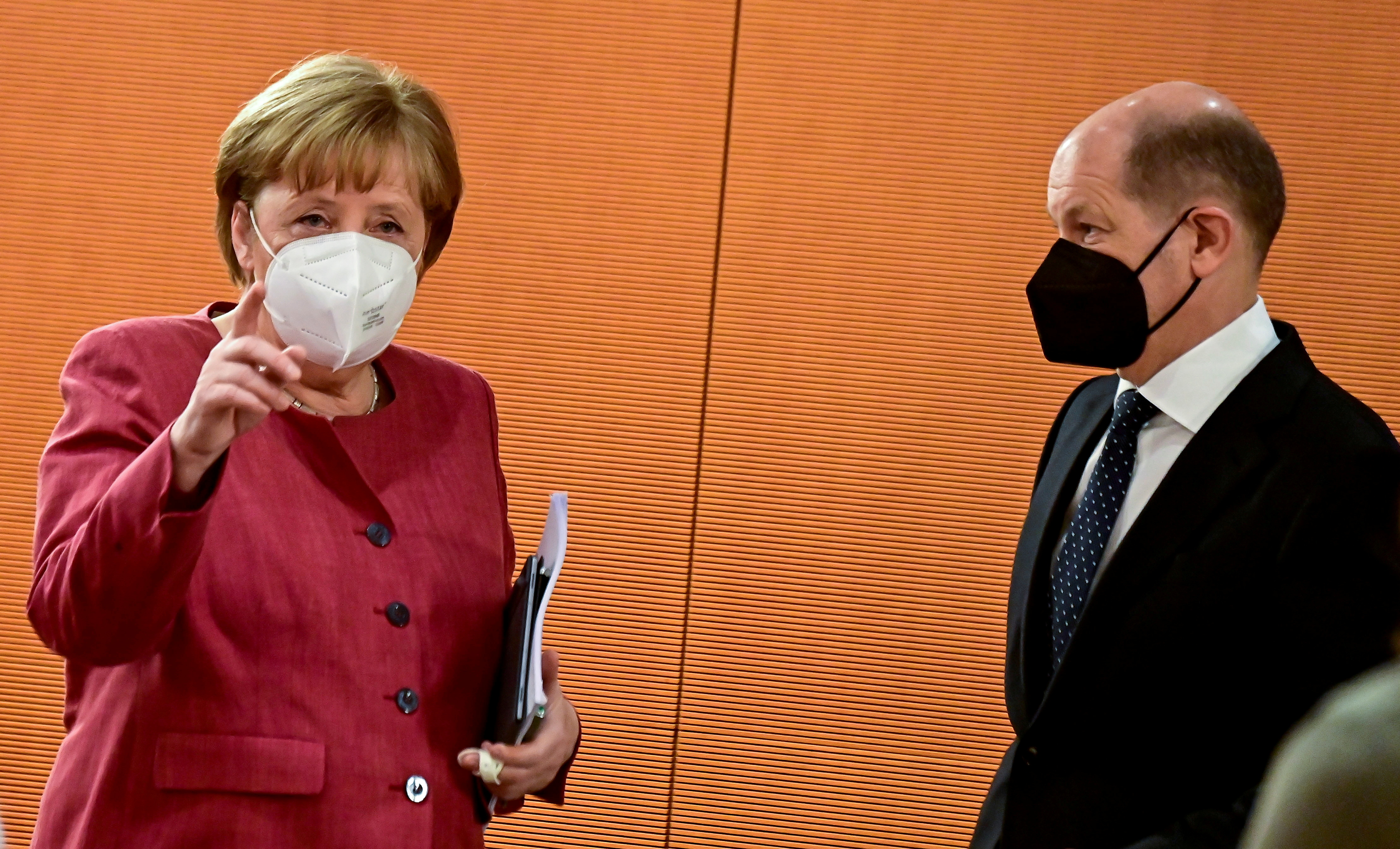 German Chancellor Angela Merkel and Finance Minister and Vice-Chancellor Olaf Scholz arrive for the weekly cabinet meeting at the Chancellery in Berlin, Germany April 21, 2021. Tobias Schwarz/Pool via REUTERS/File Photo