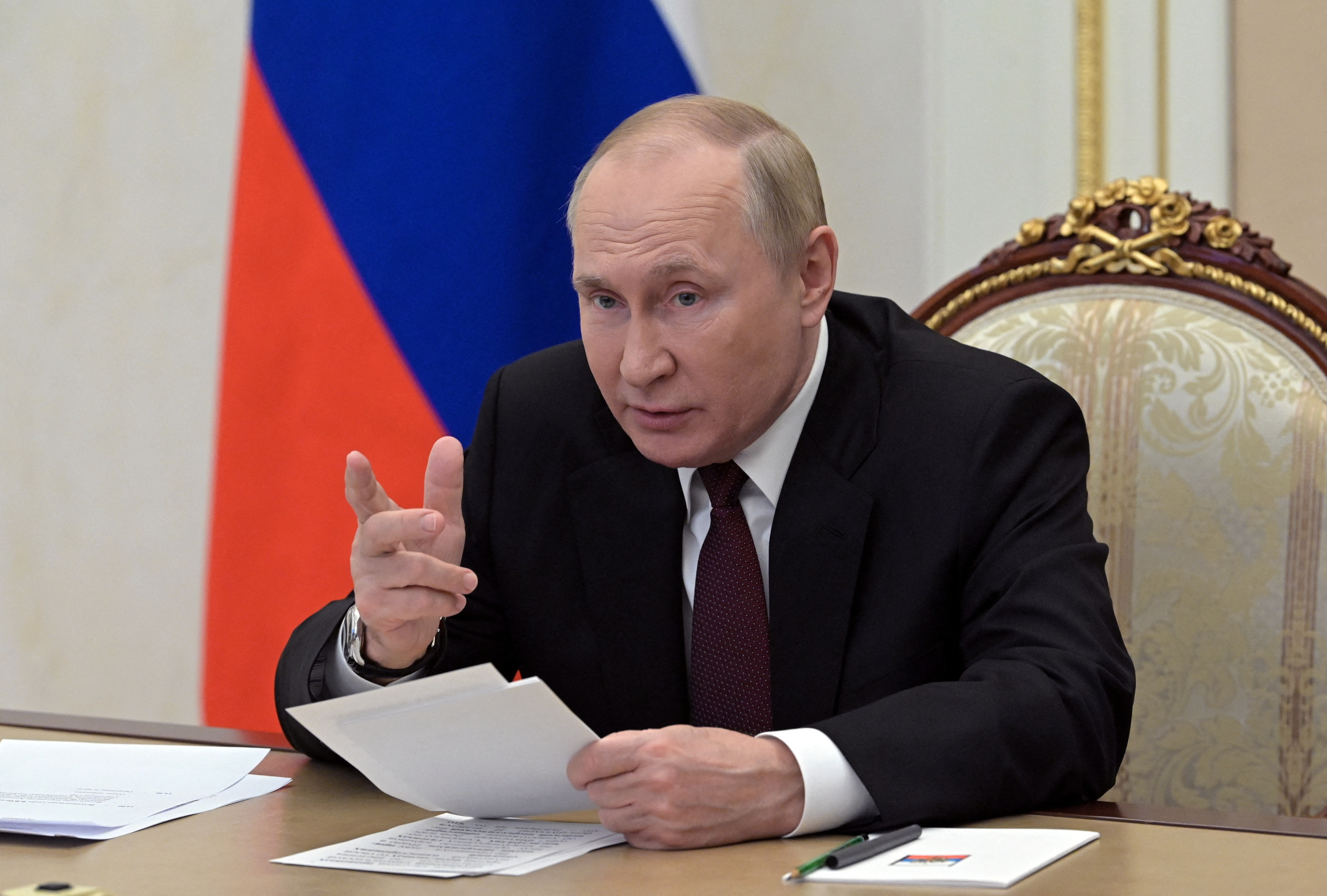 Russian President Vladimir Putin addresses the head of the CIS security agency via video link in Moscow