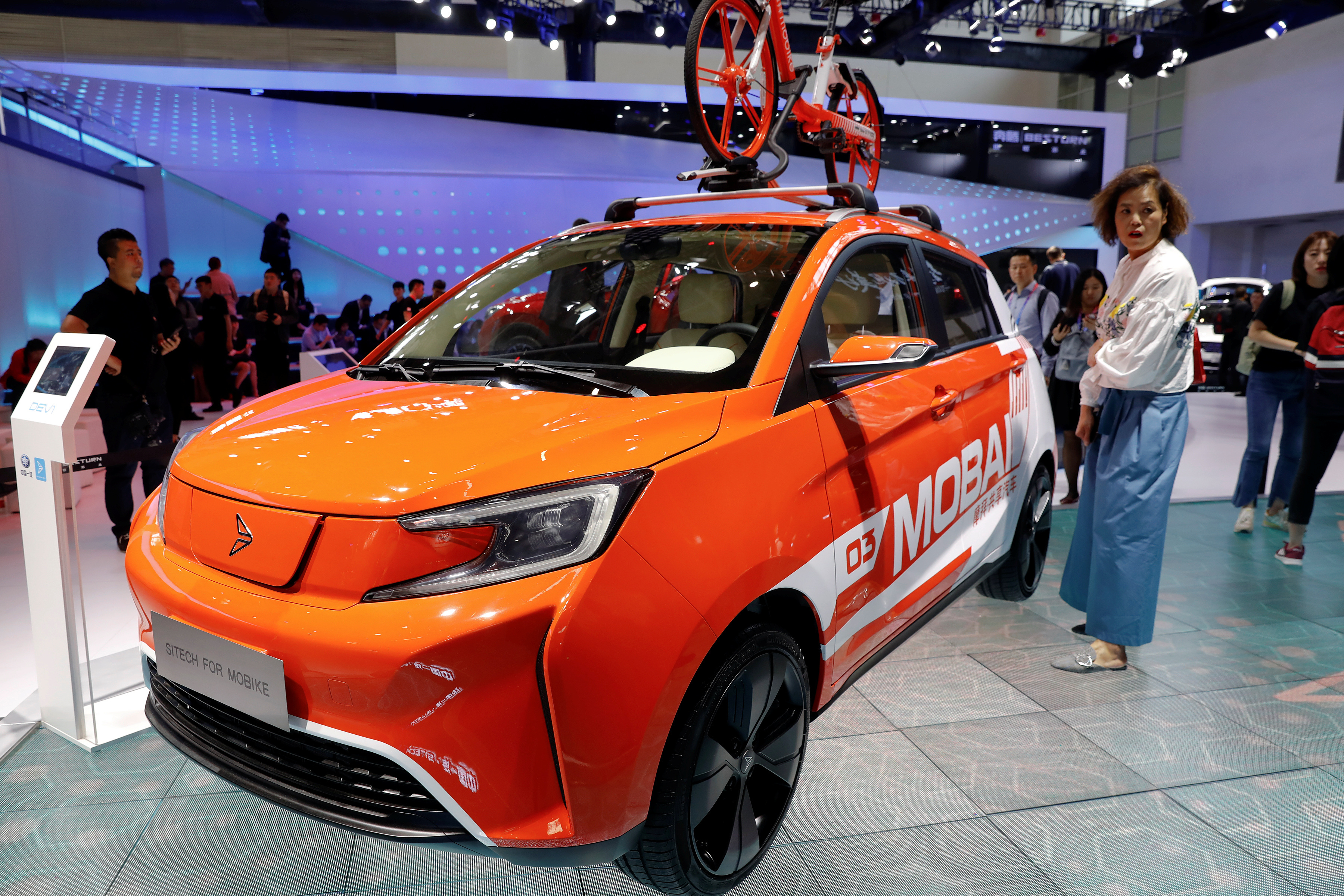 People gather around the Sitech DEV1 from FAW Group during a media preview of the Auto China 2018 motor show in Beijing