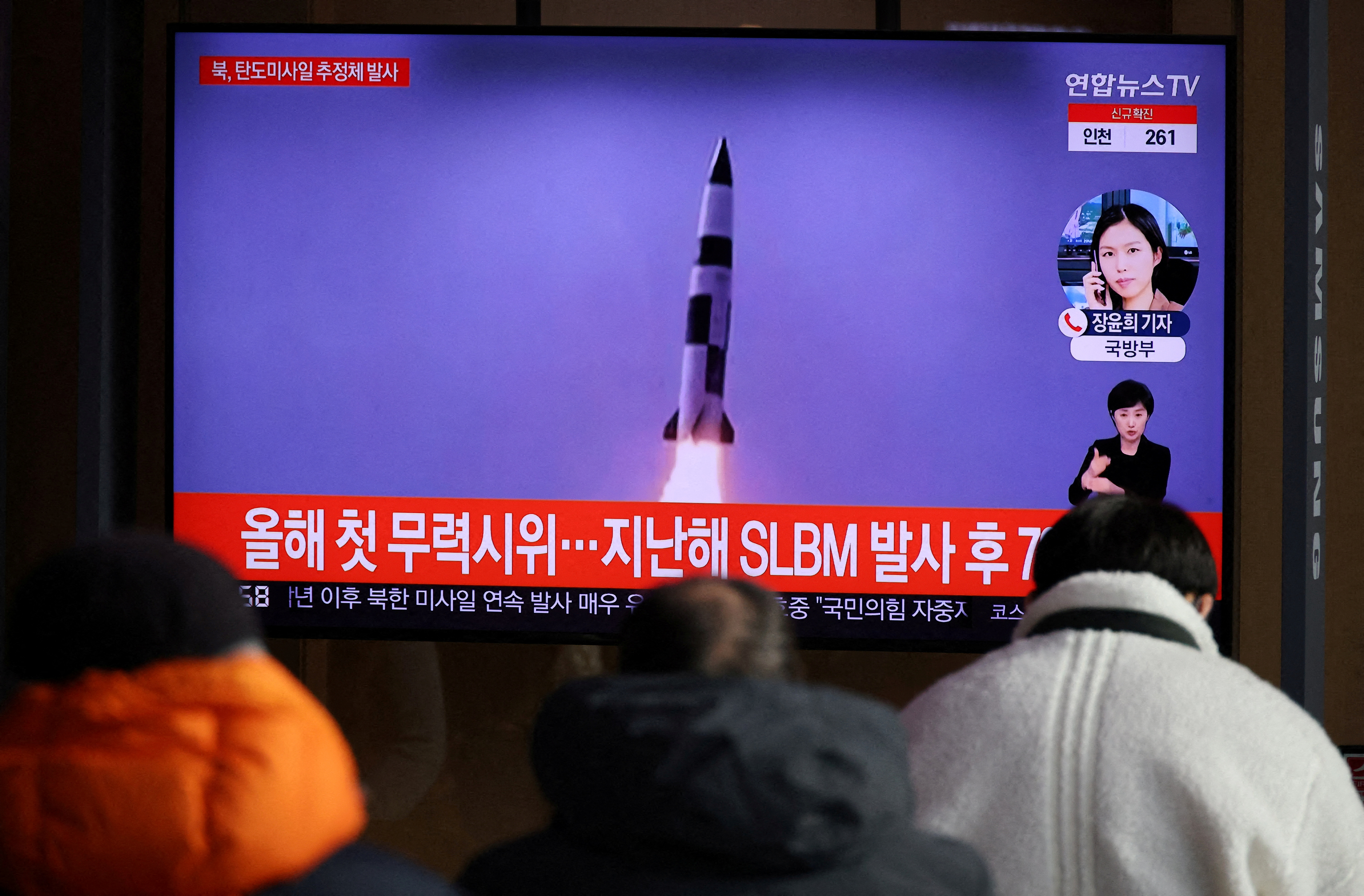 People watch a TV broadcasting file footage of a news report on North Korea firing a ballistic missile off its east coast in Seoul