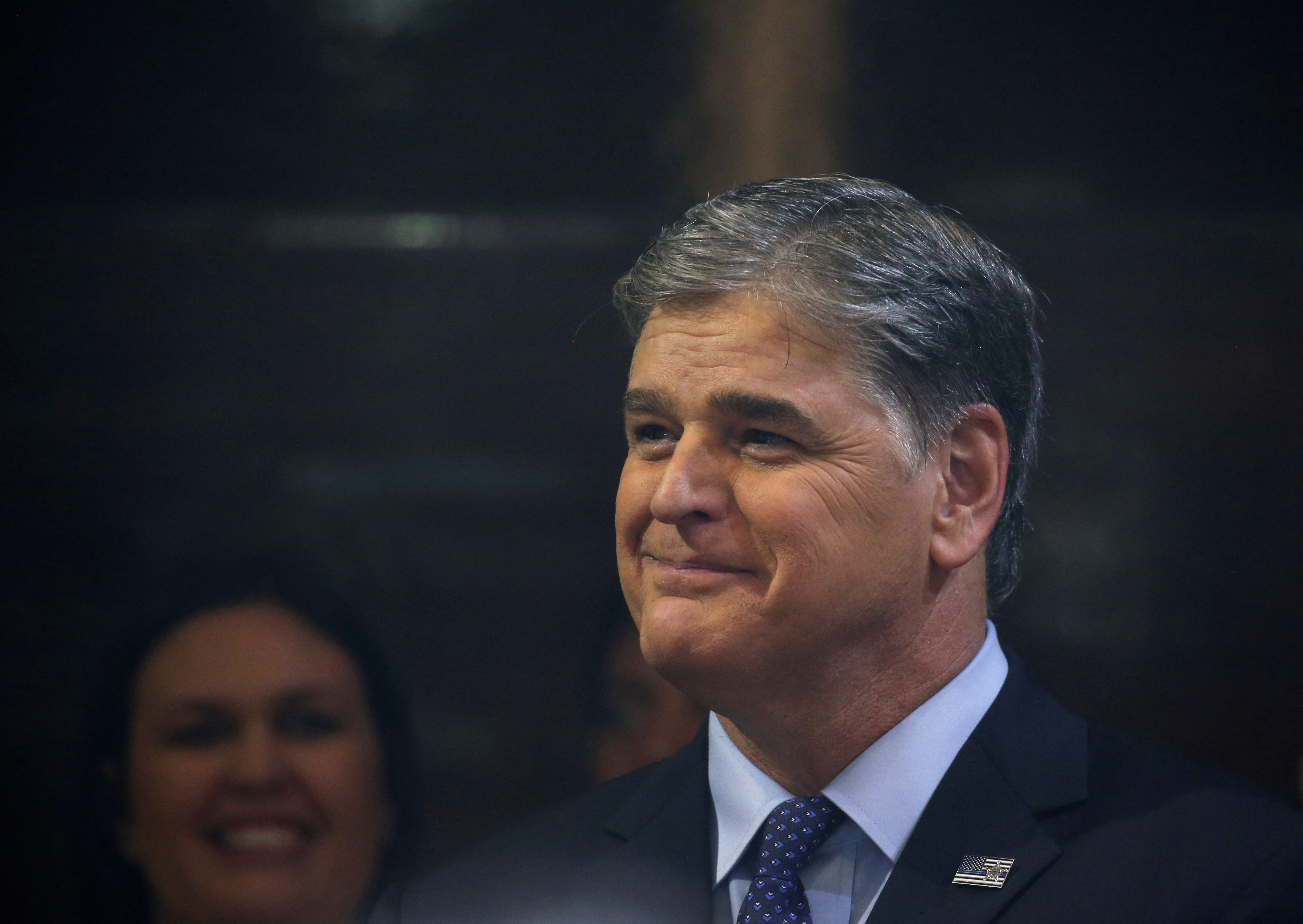 Sean Hannity from Fox News looks on as U.S. President Donald Trump holds a news conference after his summit with North Korean leader Kim Jong Un at the JW Marriott hotel in Hanoi