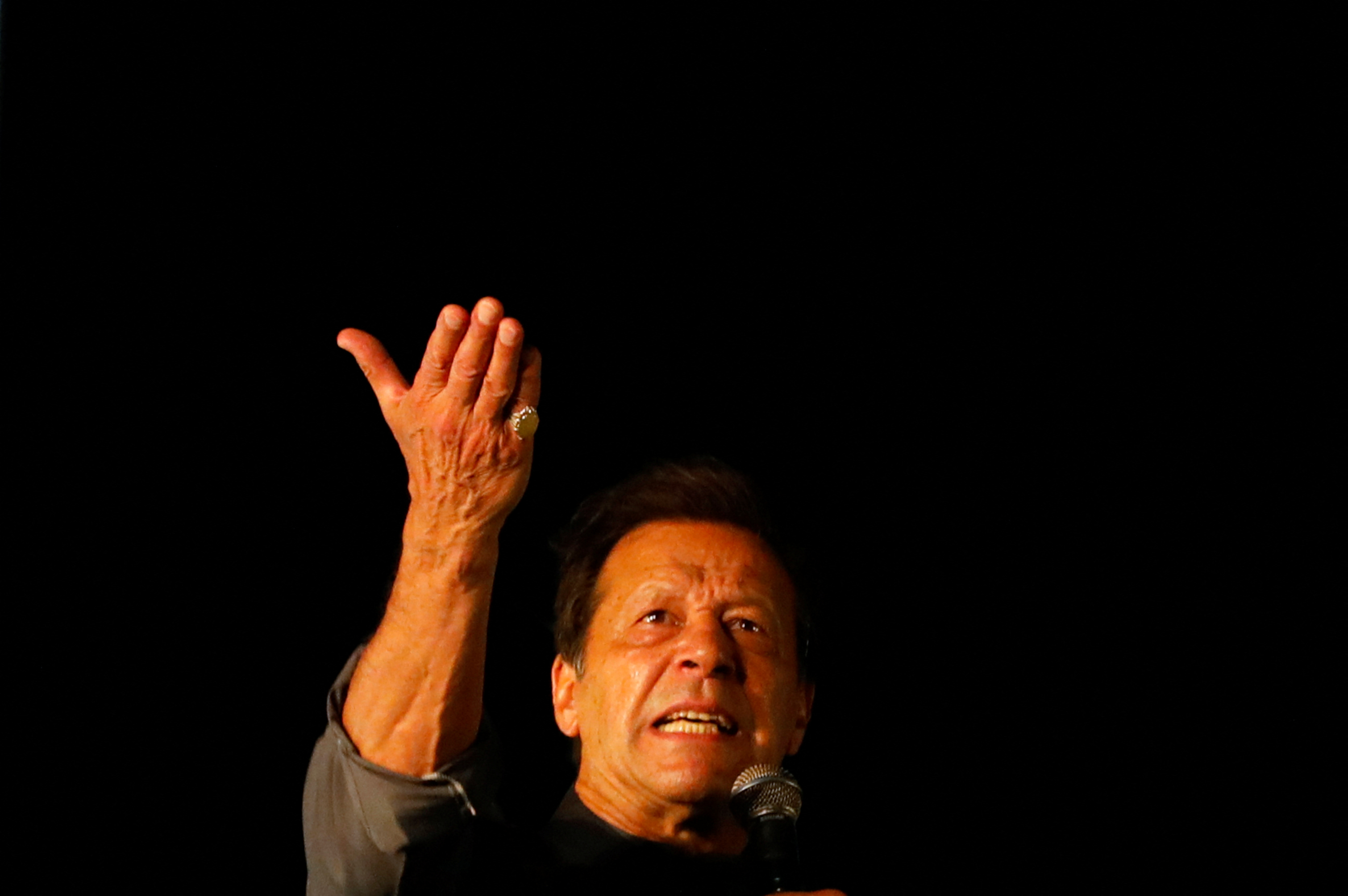 Ousted Pakistani Prime Minister Imran Khan gestures as he addresses supporters during a rally, in Karachi