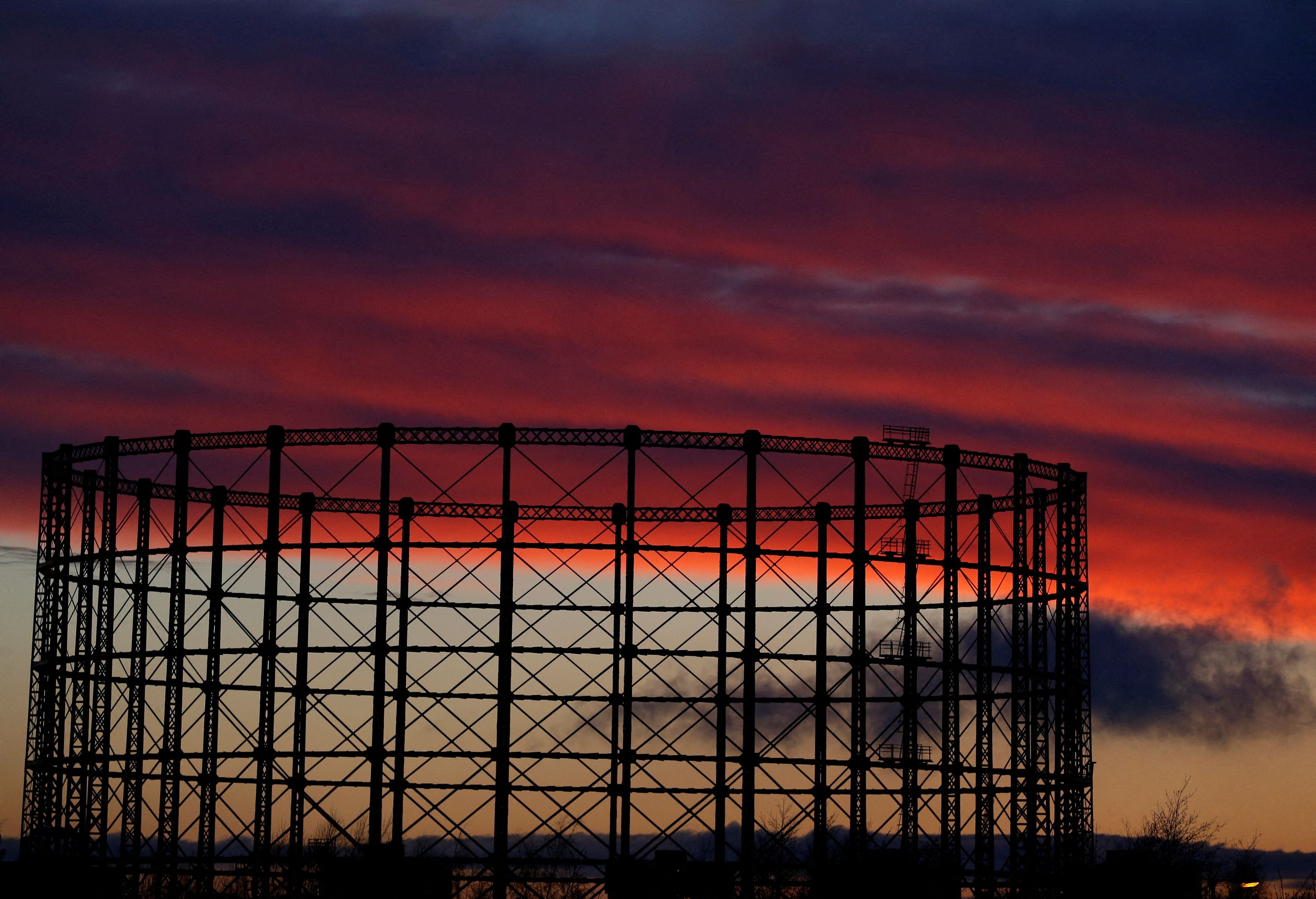 A gas storage facility is seen at sunset in Manchester