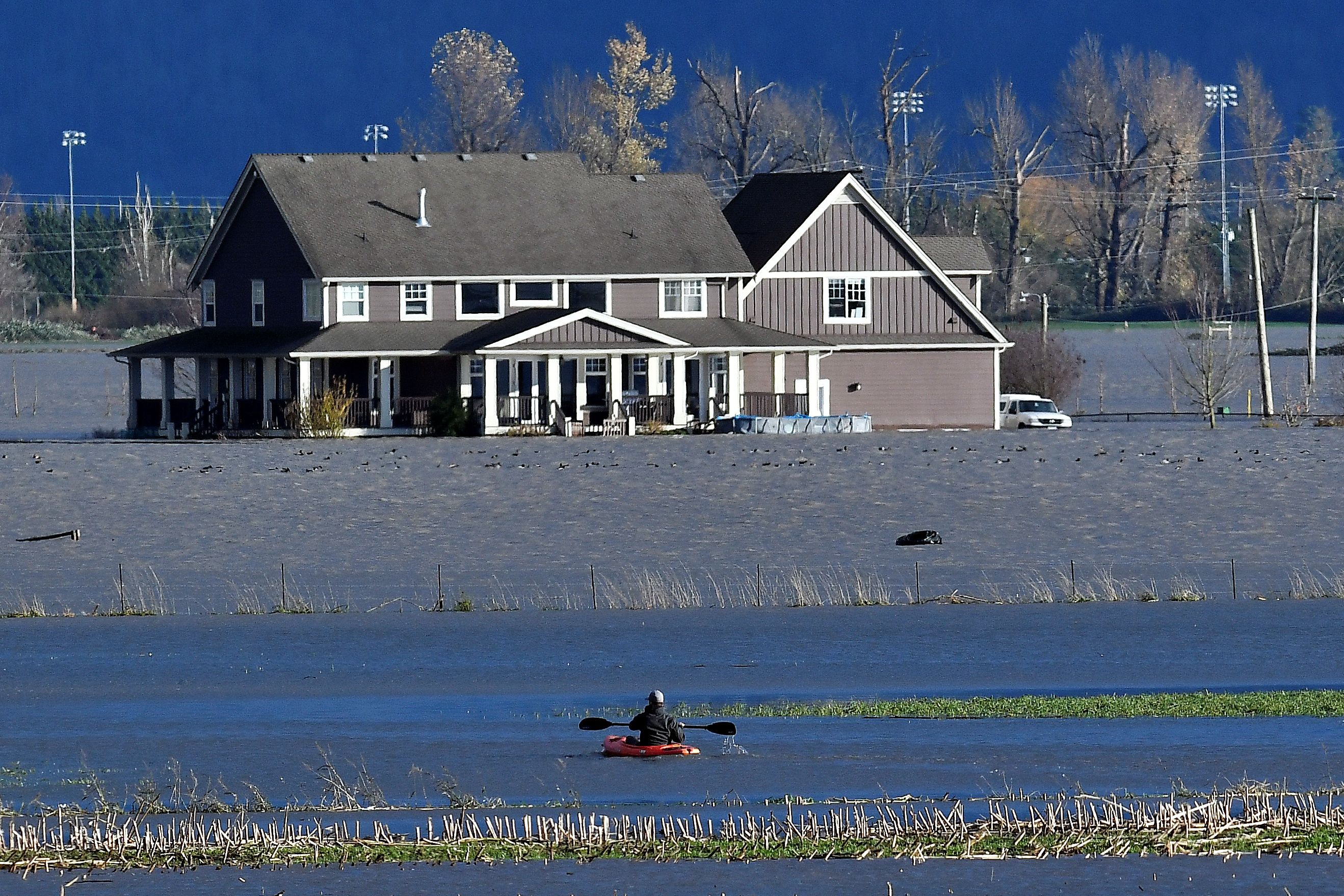A paddler kayaks on a flooded stretch of farmland after rainstorms lashed the western Canadian province of British Columbia, triggering landslides and floods and shutting highways, in Abbotsford, British Columbia, Canada November 16, 2021.  REUTERS/Jennifer Gauthier