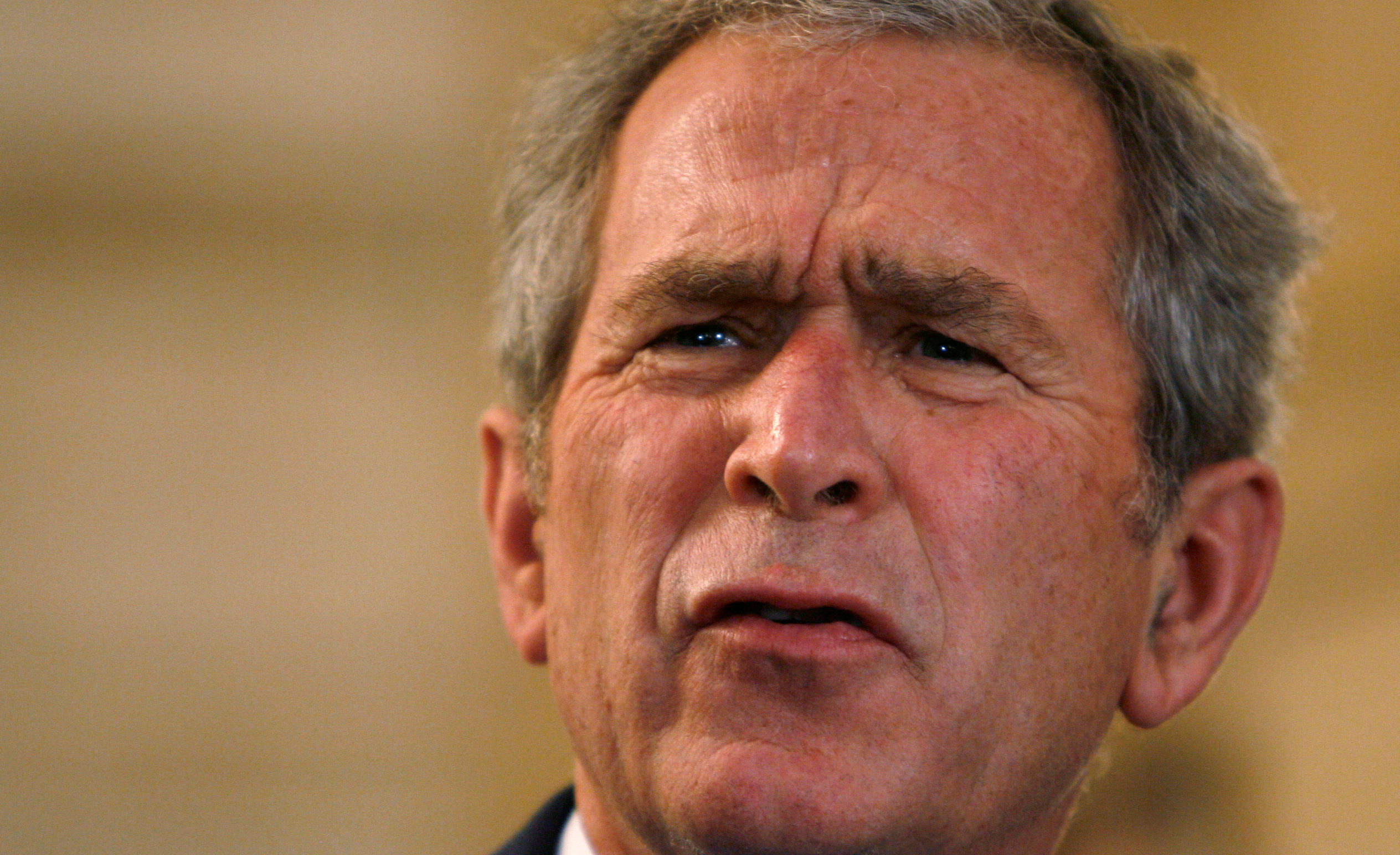 President  Bush reacts to a question after a man threw a shoe at him in Iraq