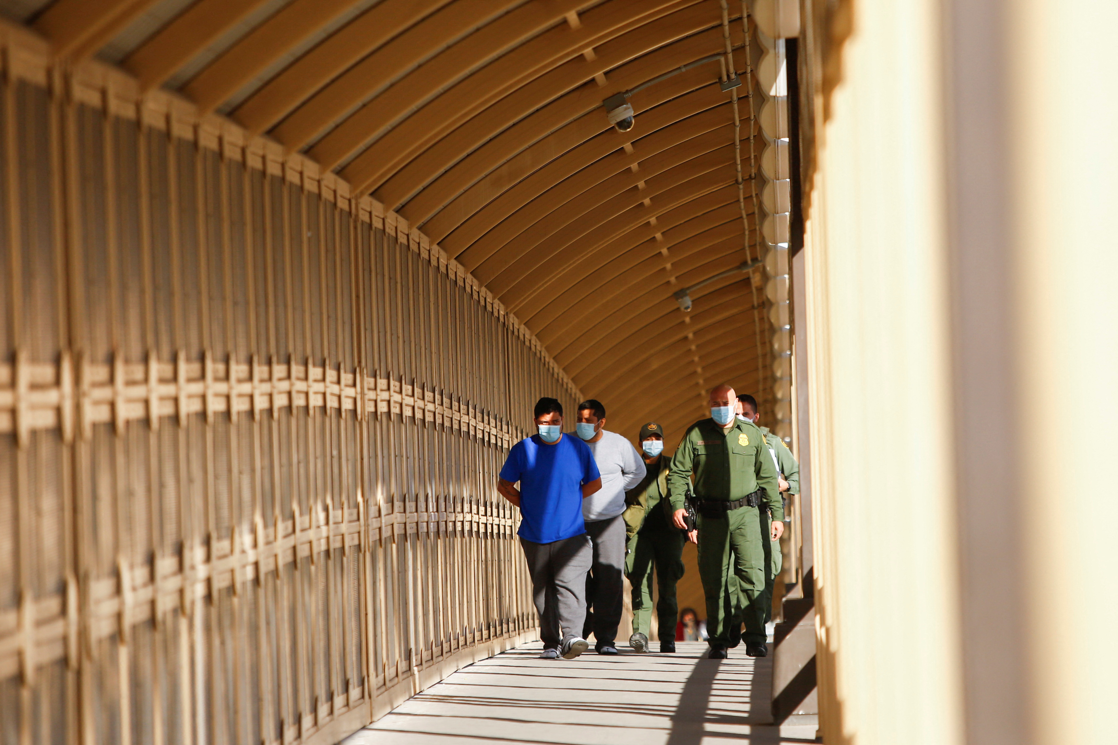 Migrants under the Migrant Protection Protocols (MPP) program, are escorted by U.S. Border Patrol Agents through the Lerdo Stanton International Border Bridge in El Paso