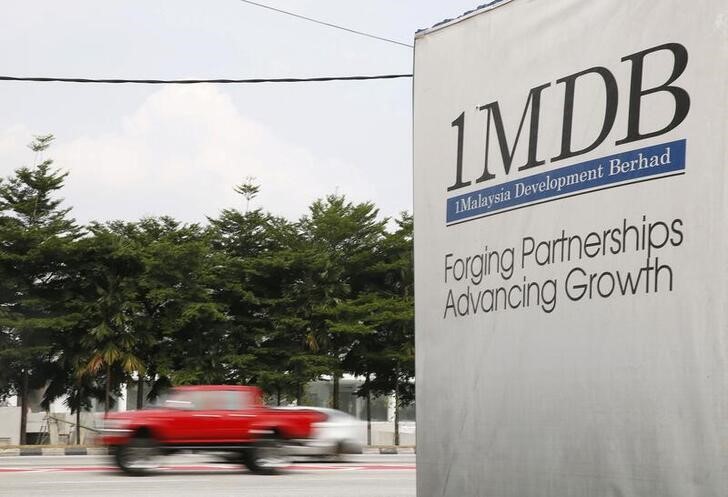 Traffic passes a 1Malaysia Development Berhad (1MDB) billboard at the Tun Razak Exchange development in Kuala Lumpur, Malaysia
