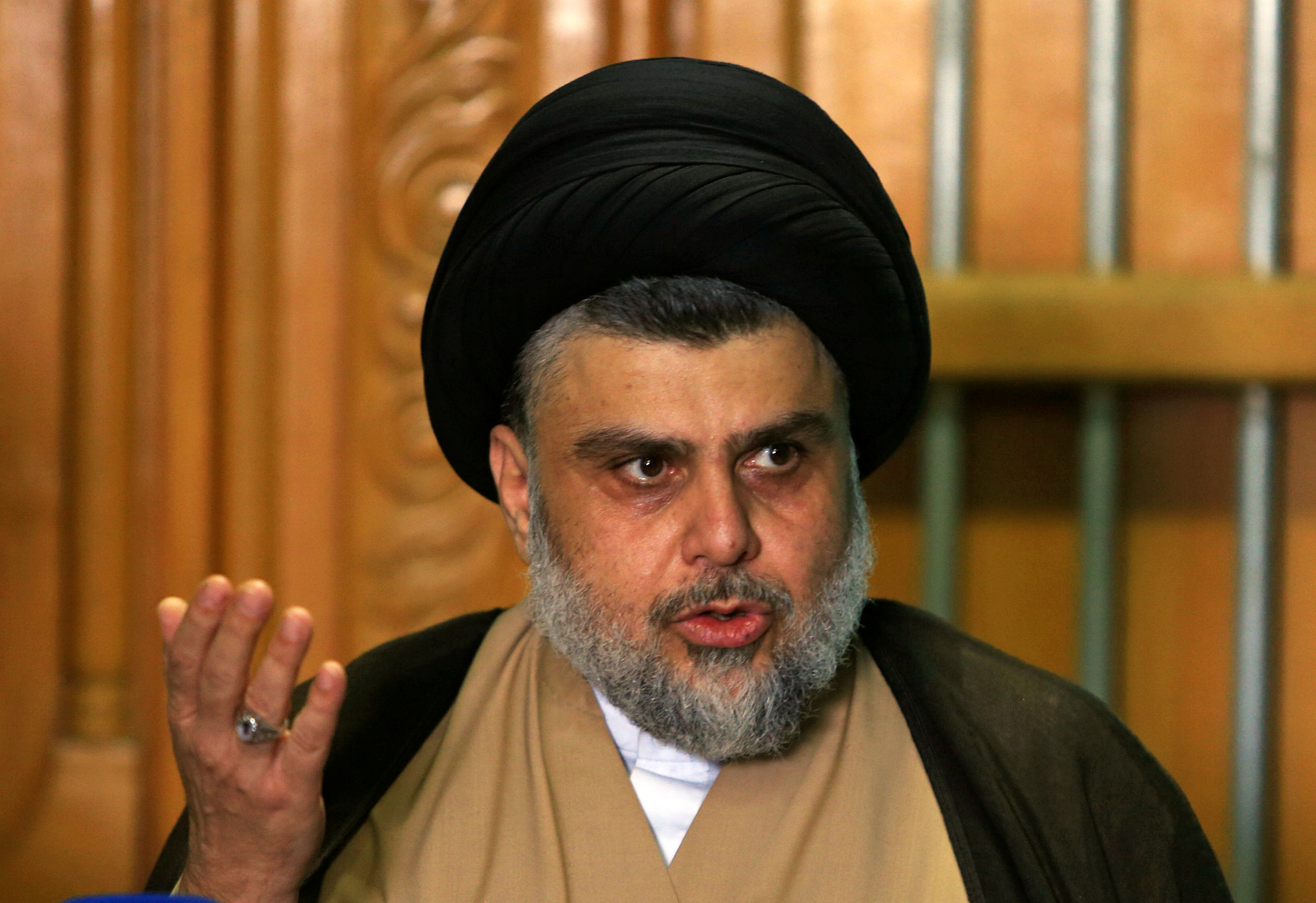 Iraqi Shi'ite cleric Moqtada al-Sadr speaks during a news conference with Iraqi politician Ammar al-Hakim, leader of the Hikma Current, in Najaf