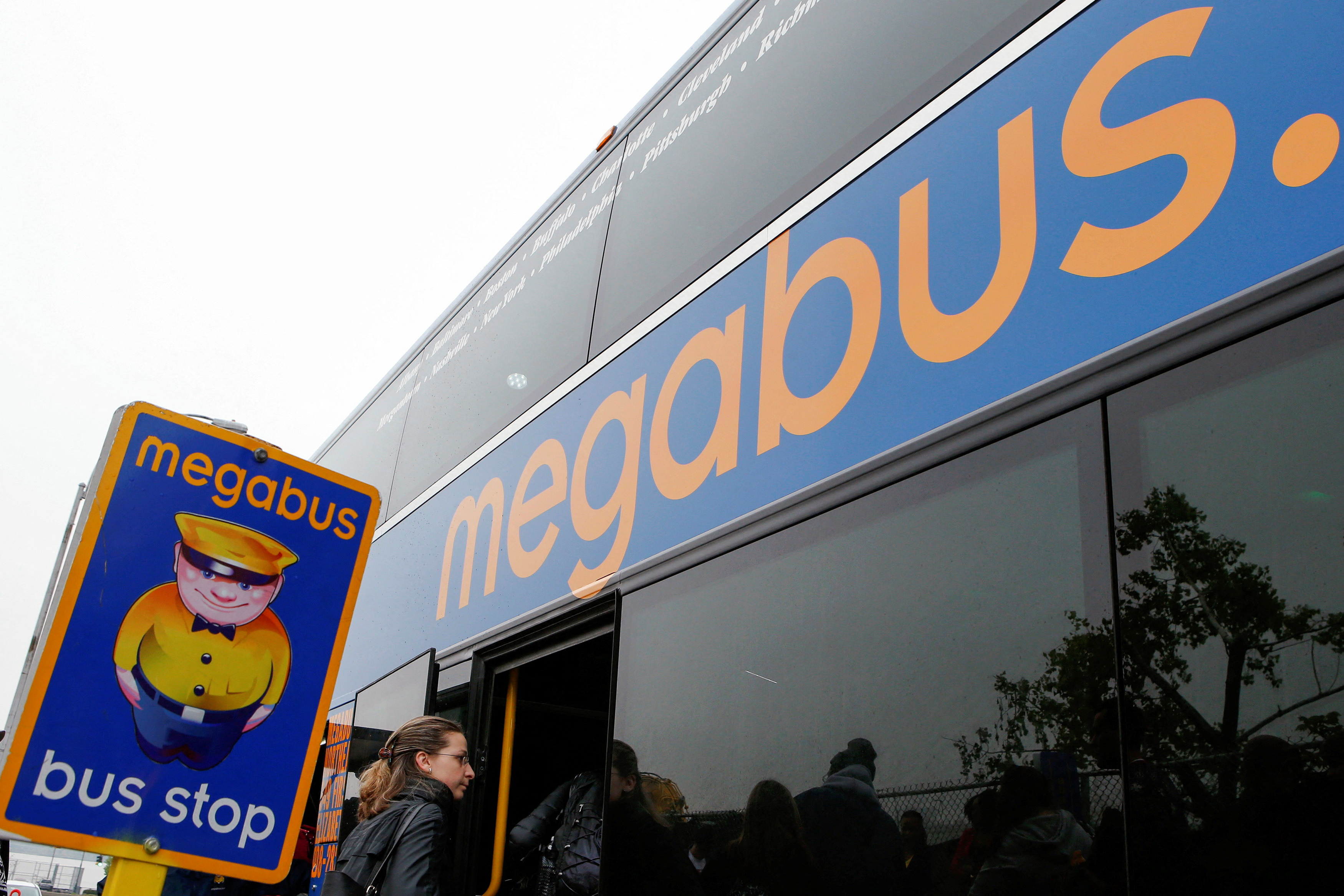 Passengers board a Megabus bus in New York City