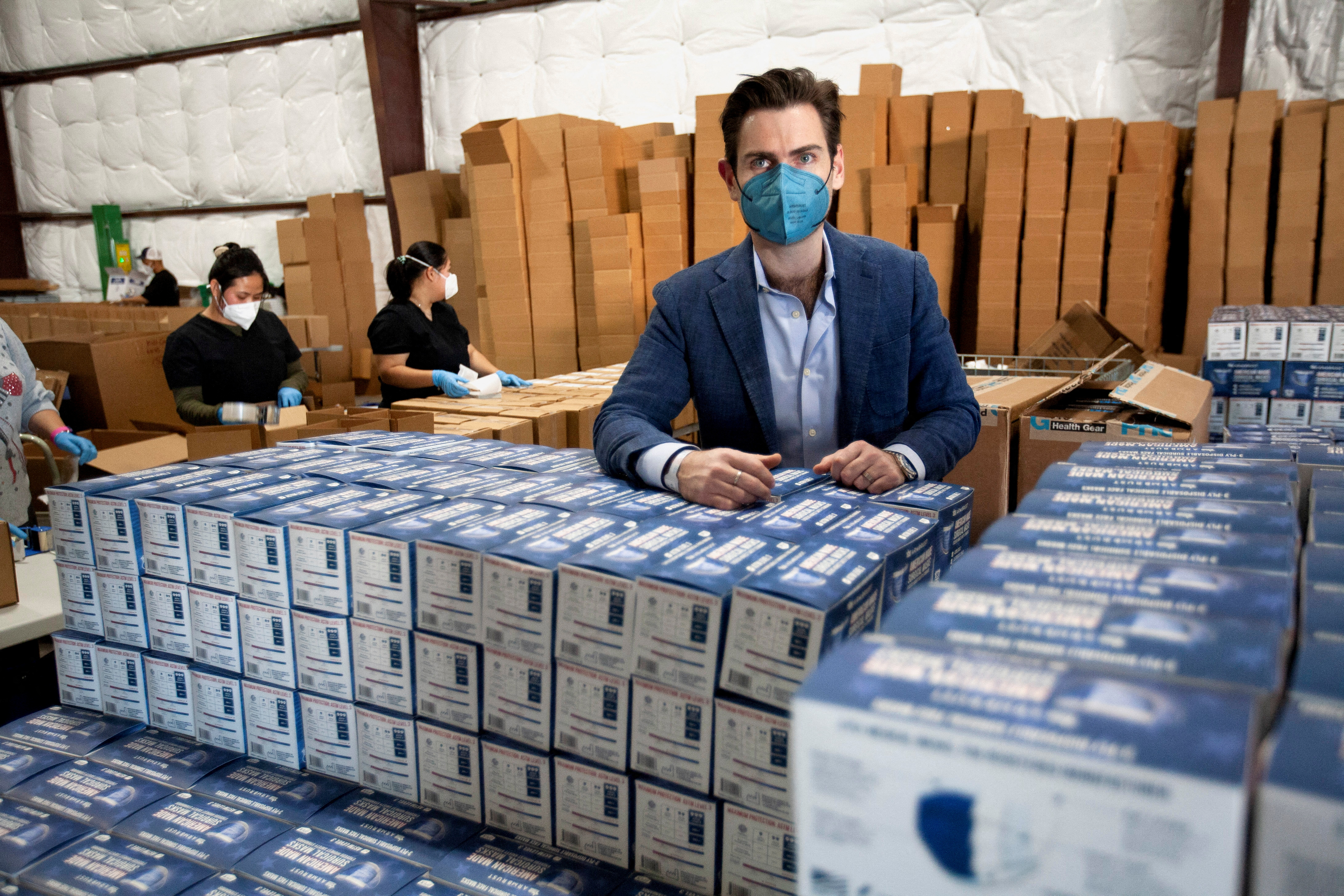 Armbrust American founder and Chief Executive Officer Lloyd Armbrust displays some of his masks at his company's warehouse in Pflugerville, Texas, U.S., January 12, 2022.  He said he is shipping an average of 250,000 masks per day now. REUTERS/Nuri Vallbona