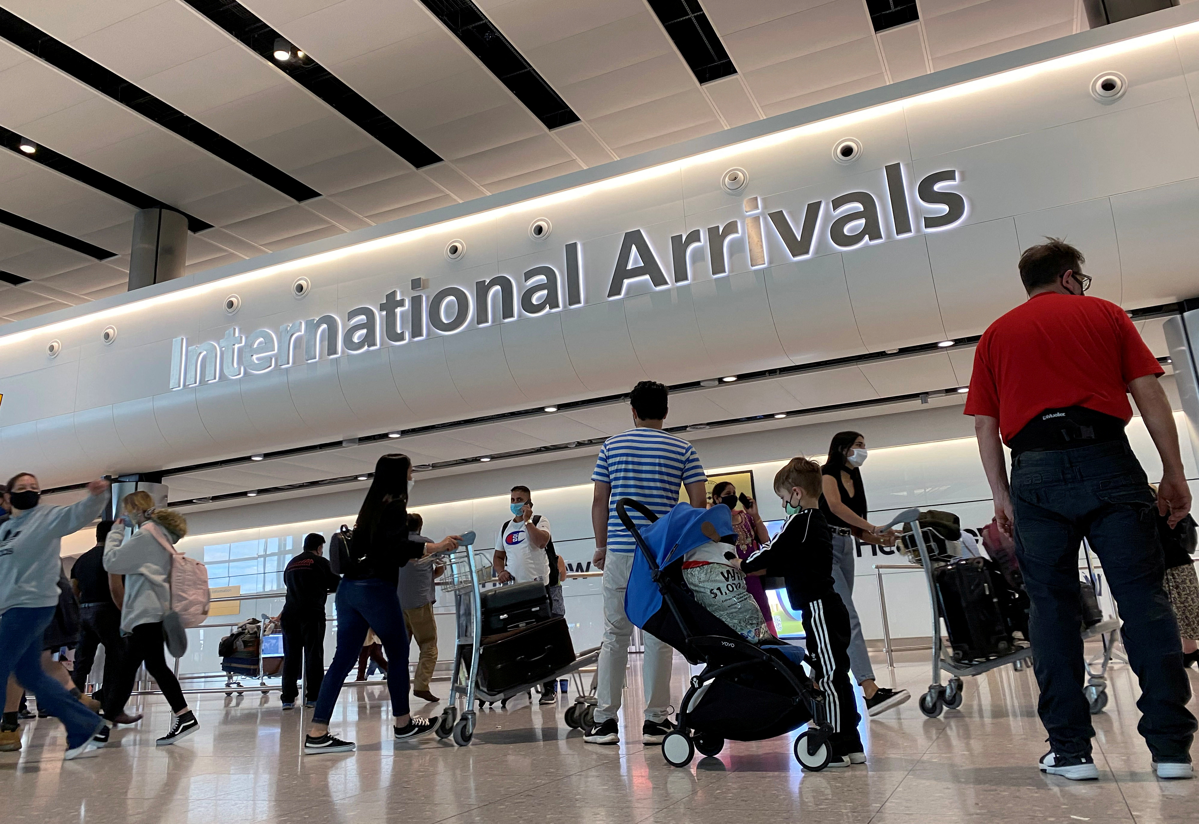 FILE PHOTO: Passengers from international flights arrive at Heathrow Airport, following the outbreak of the coronavirus disease (COVID-19), London, Britain