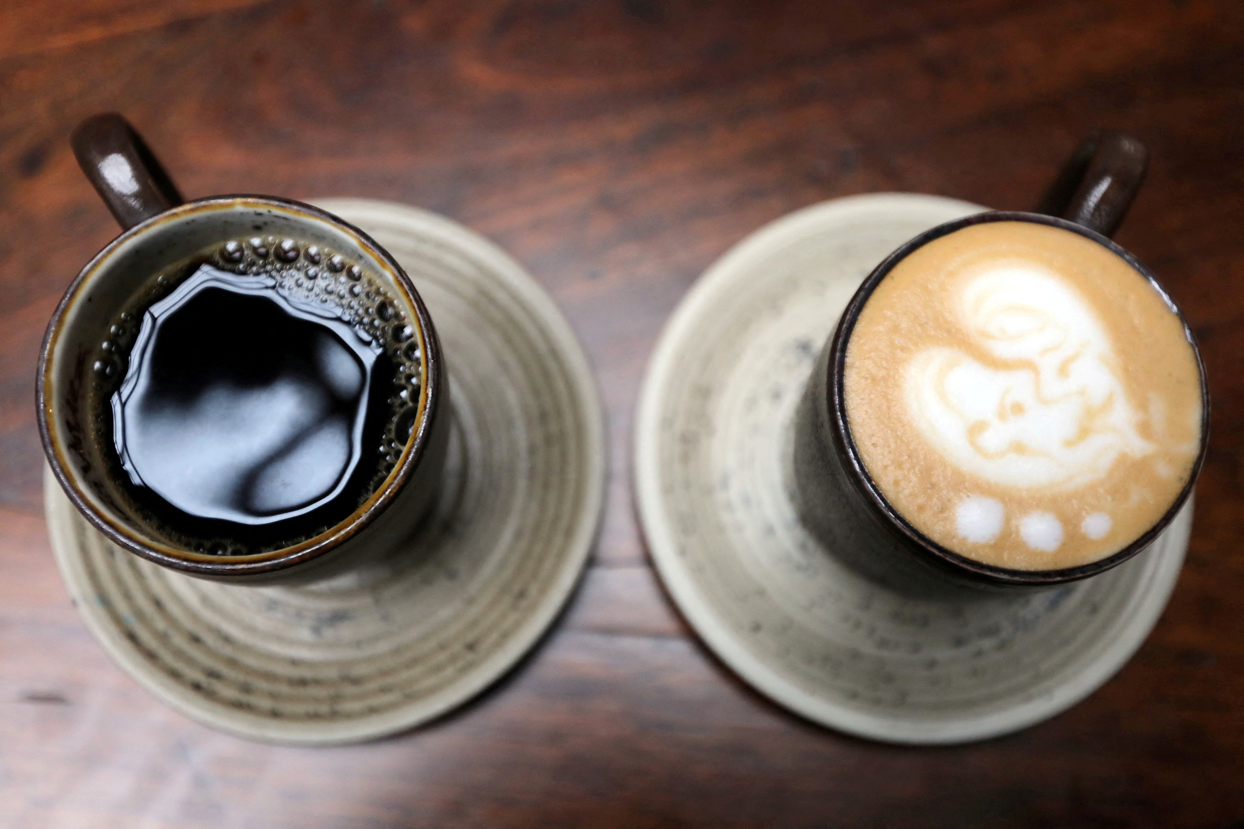 A cup of coffee and a cappuccino are seen at a Juan Valdez store in Bogota