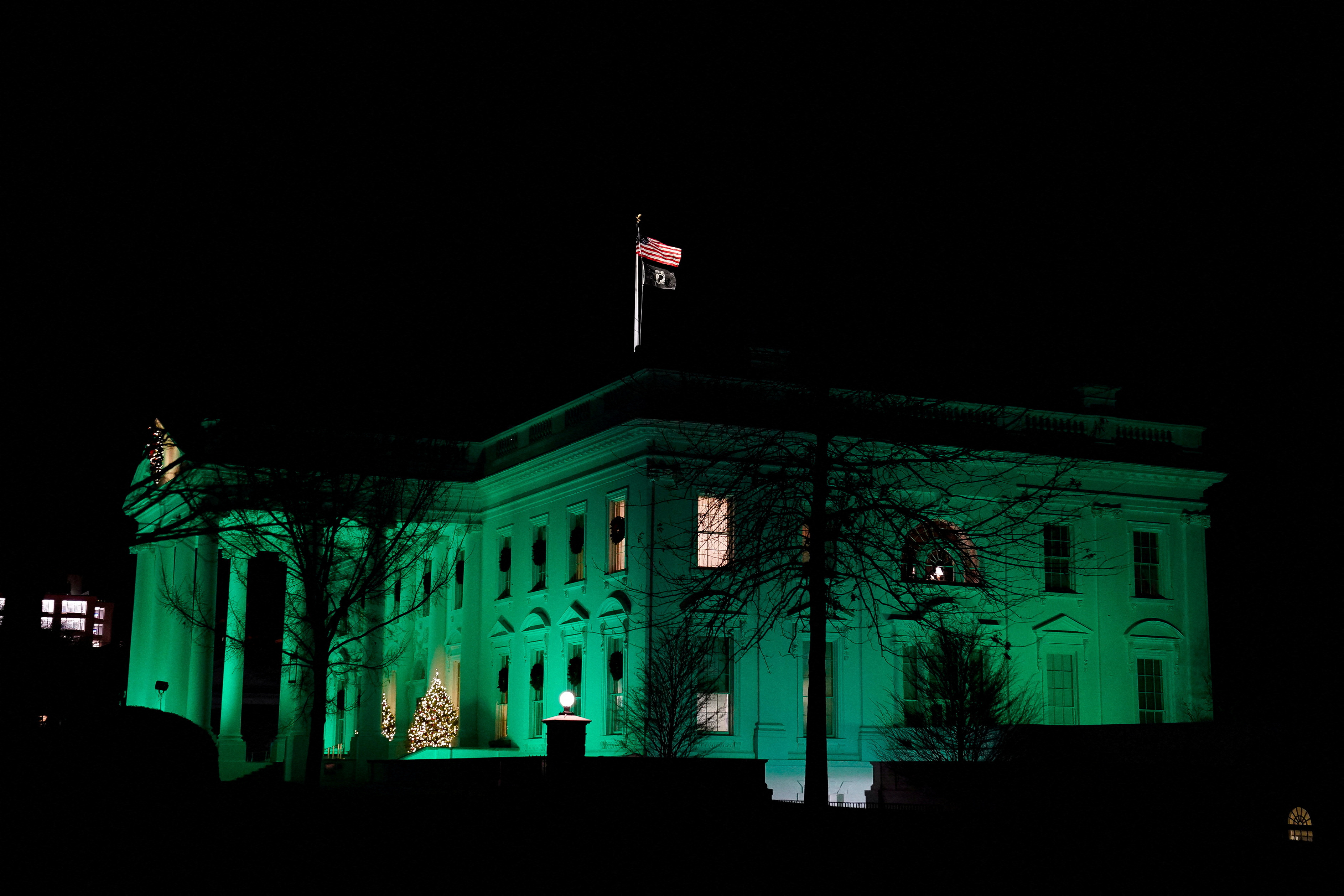 Green lights illuminate the White House on the 10th anniversary of the shooting at Sandy Hook Elementary School, in Washington