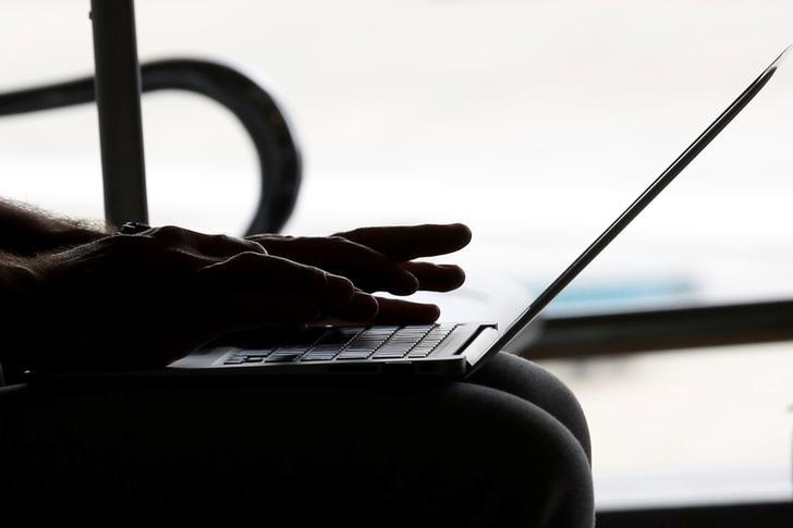 Man works with a laptop at the airport in Hanoi