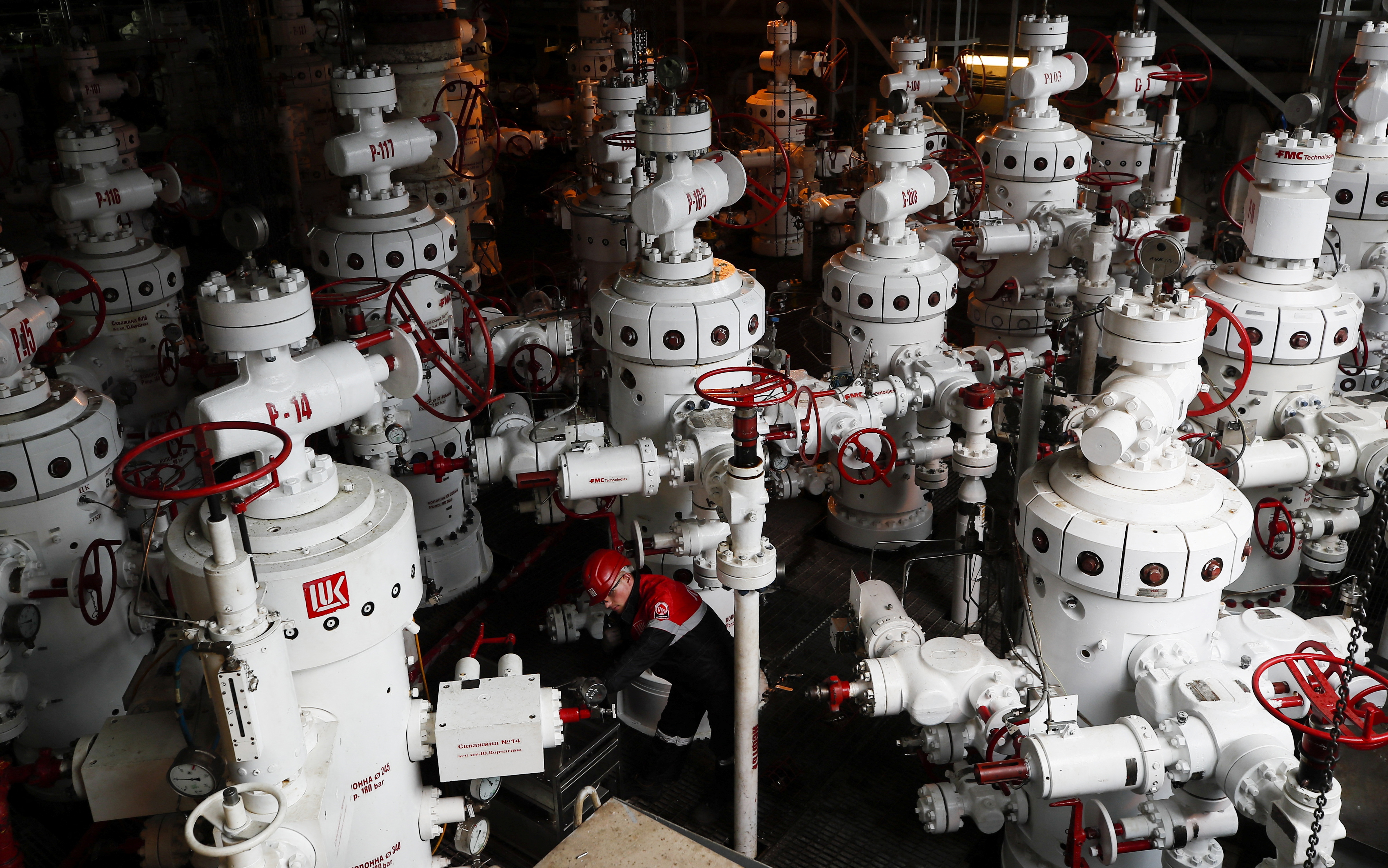 A specialist inspects valves at the Korchagina oil platform operated by Lukoil company in Caspian Sea