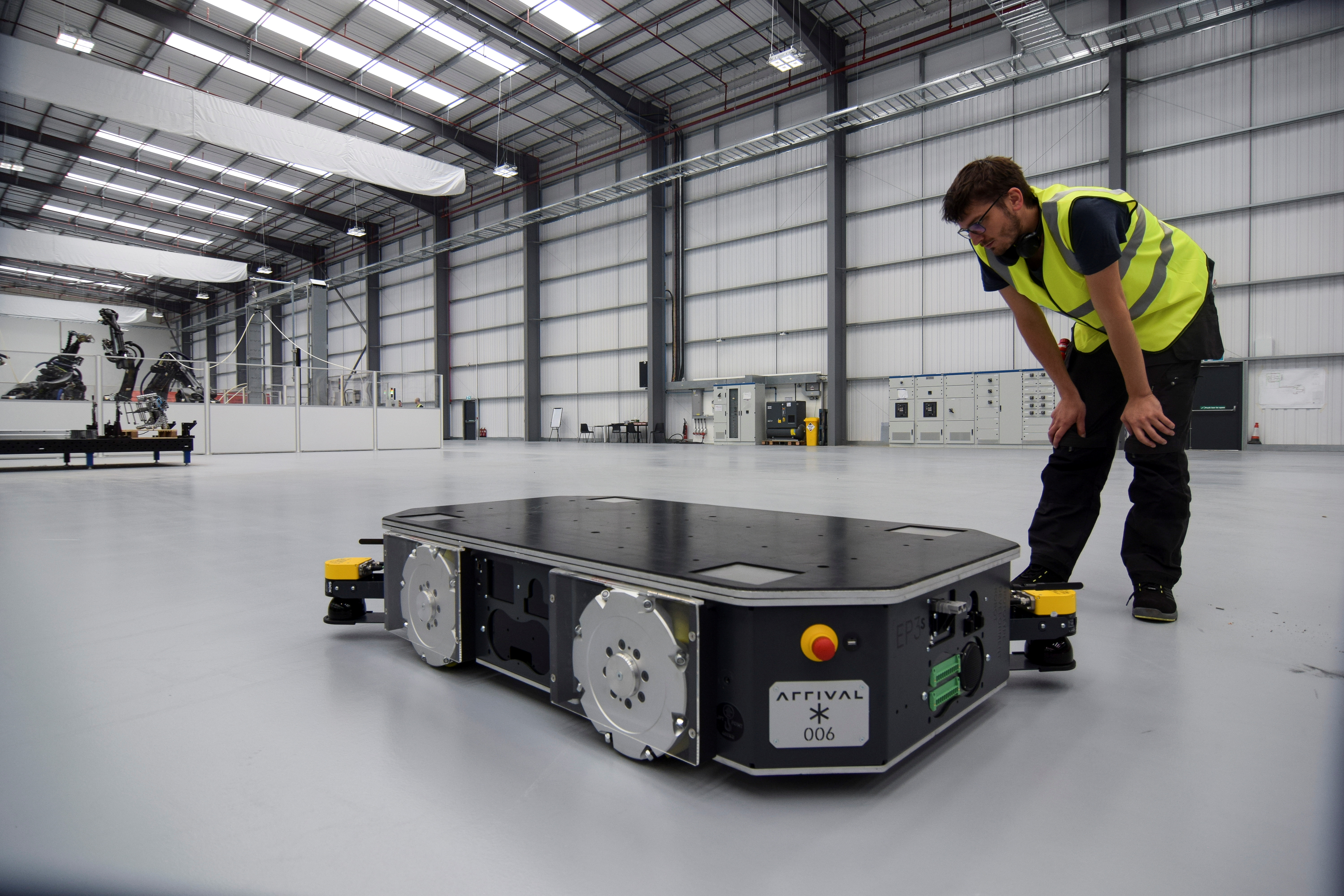An engineer at UK electric van and bus maker Arrival inspects a specially developed autonomous robot at the startup's low-cost "microfactory" in Bicester, Britain, August 3, 2021. REUTERS/Nick Carey