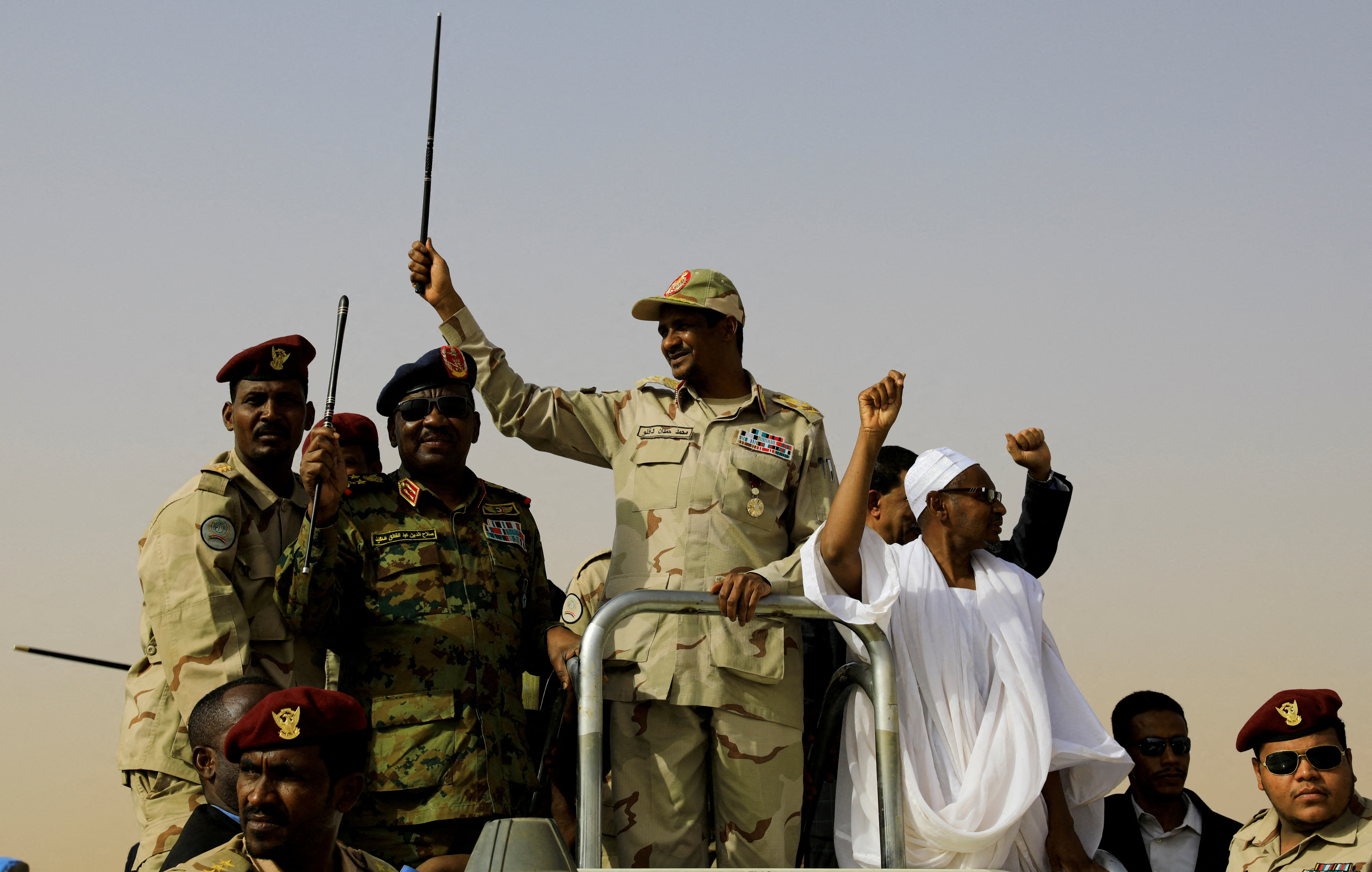 Lieutenant General Mohamed Hamdan Dagalo greets his supporters as he arrives at a meeting in Aprag village