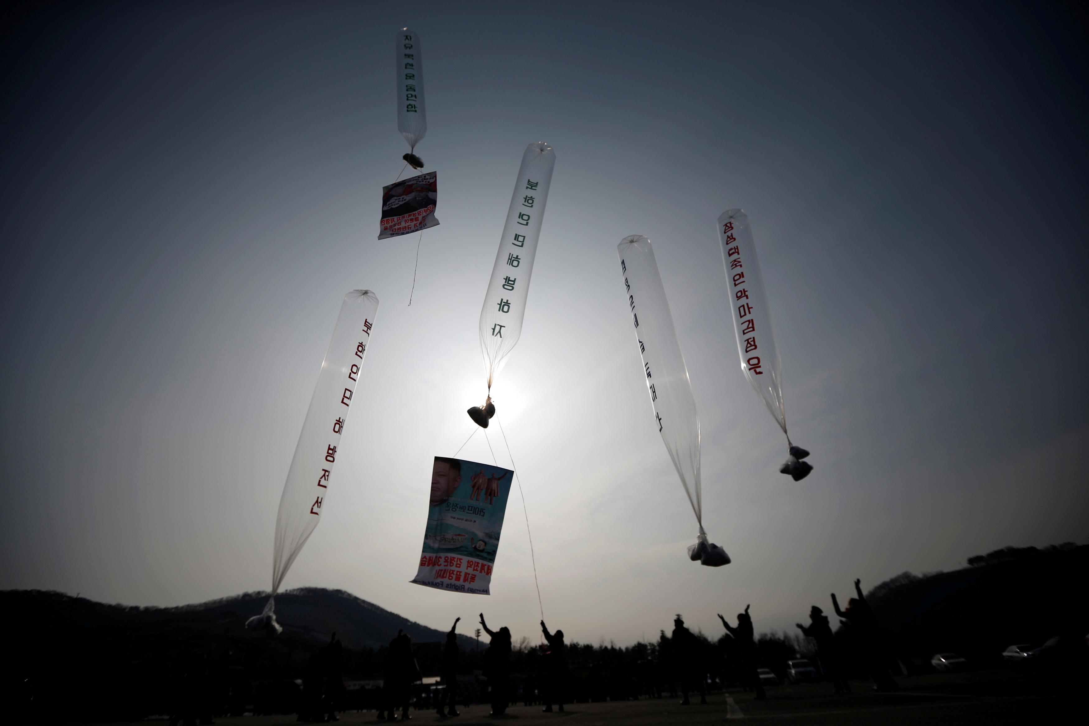Former North Korean defectors living in South Korea release balloons containing one dollar banknotes, radios, CDs and leaflets denouncing the North Korean regime towards the demilitarized zone, in Paju, north of Seoul