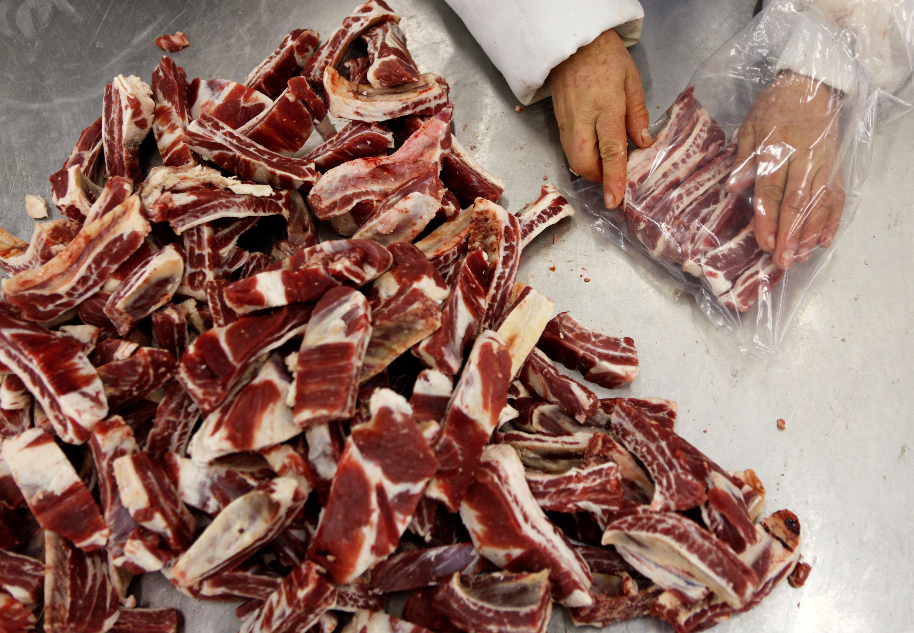 A worker packs beef at the Marfrig Group slaughter house in Promissao