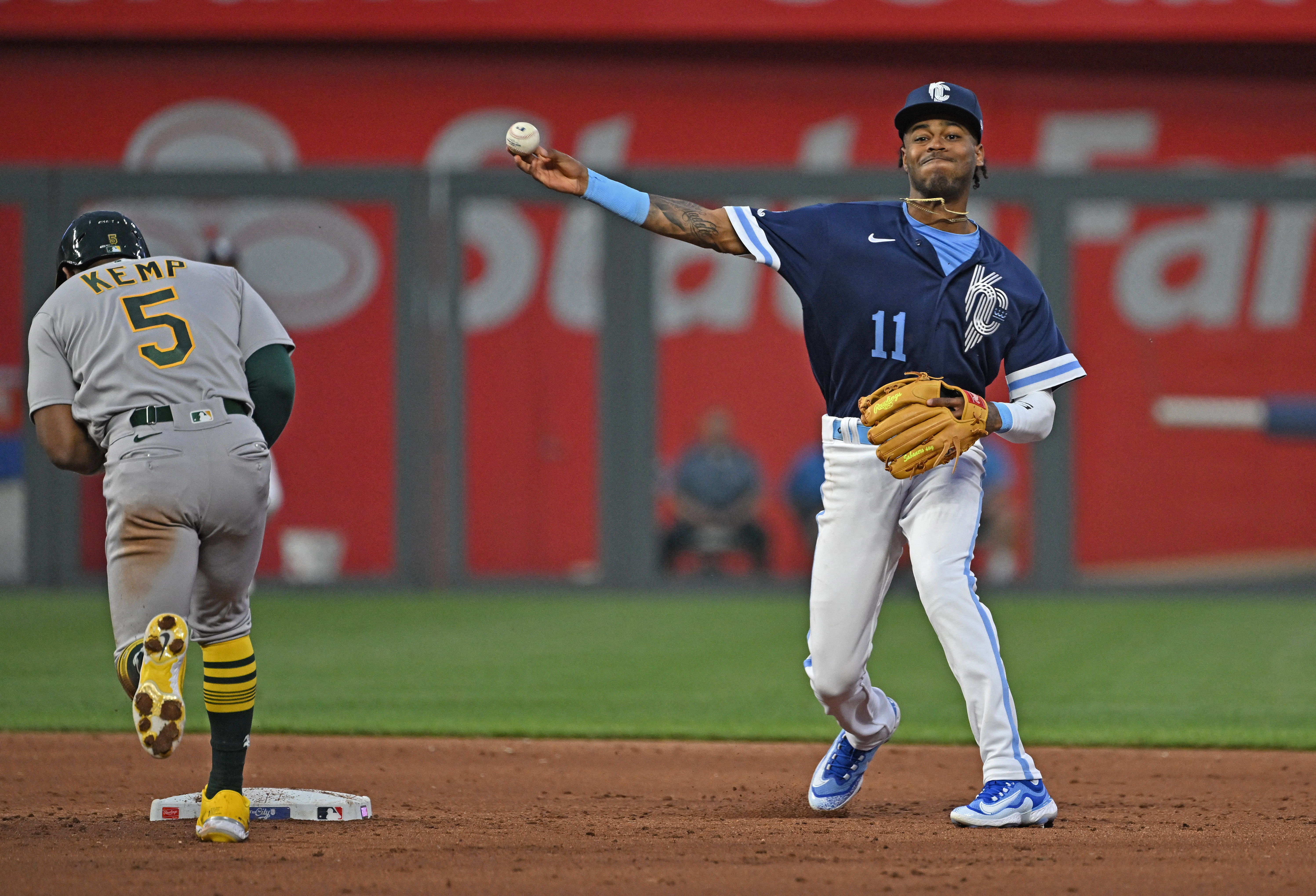 A's score big, hold off Royals' comeback bid