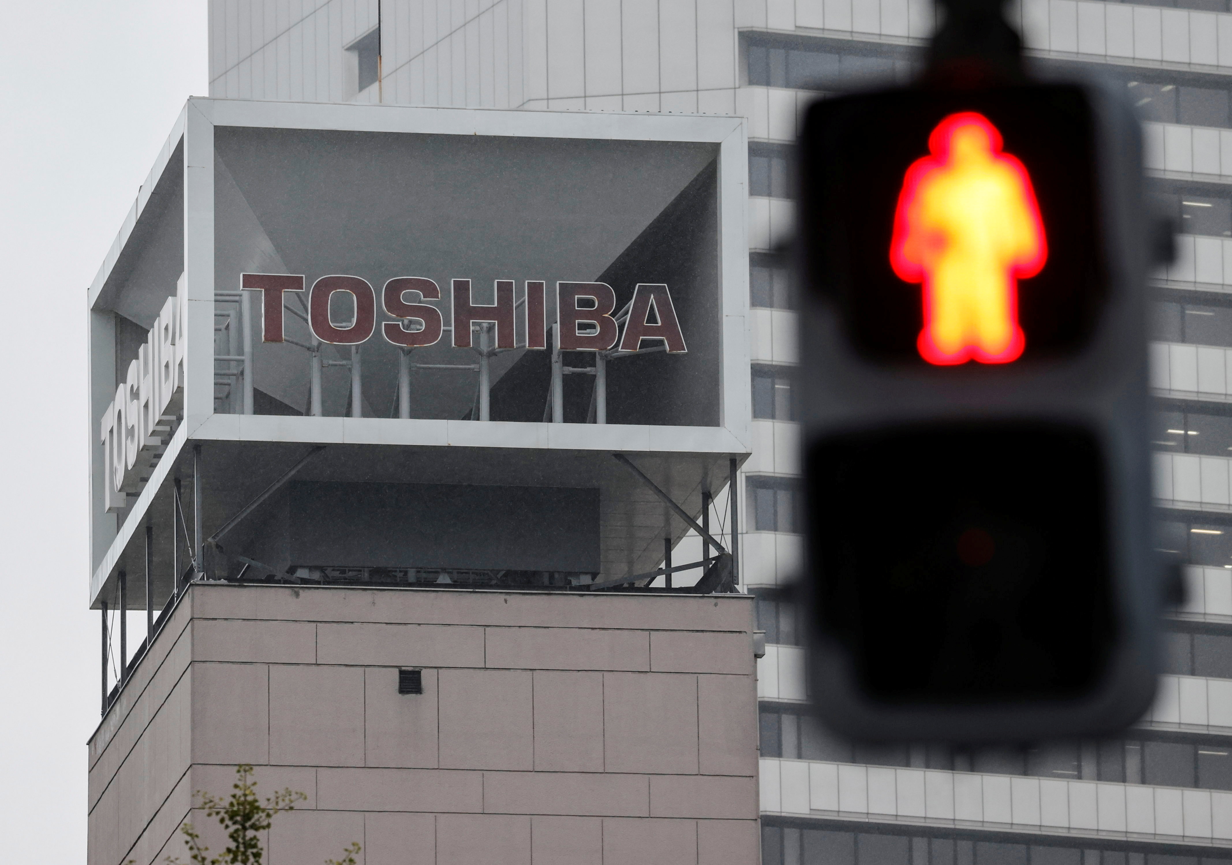 The logo of Toshiba Corp. is seen next to a traffic signal atop of a building in Tokyo