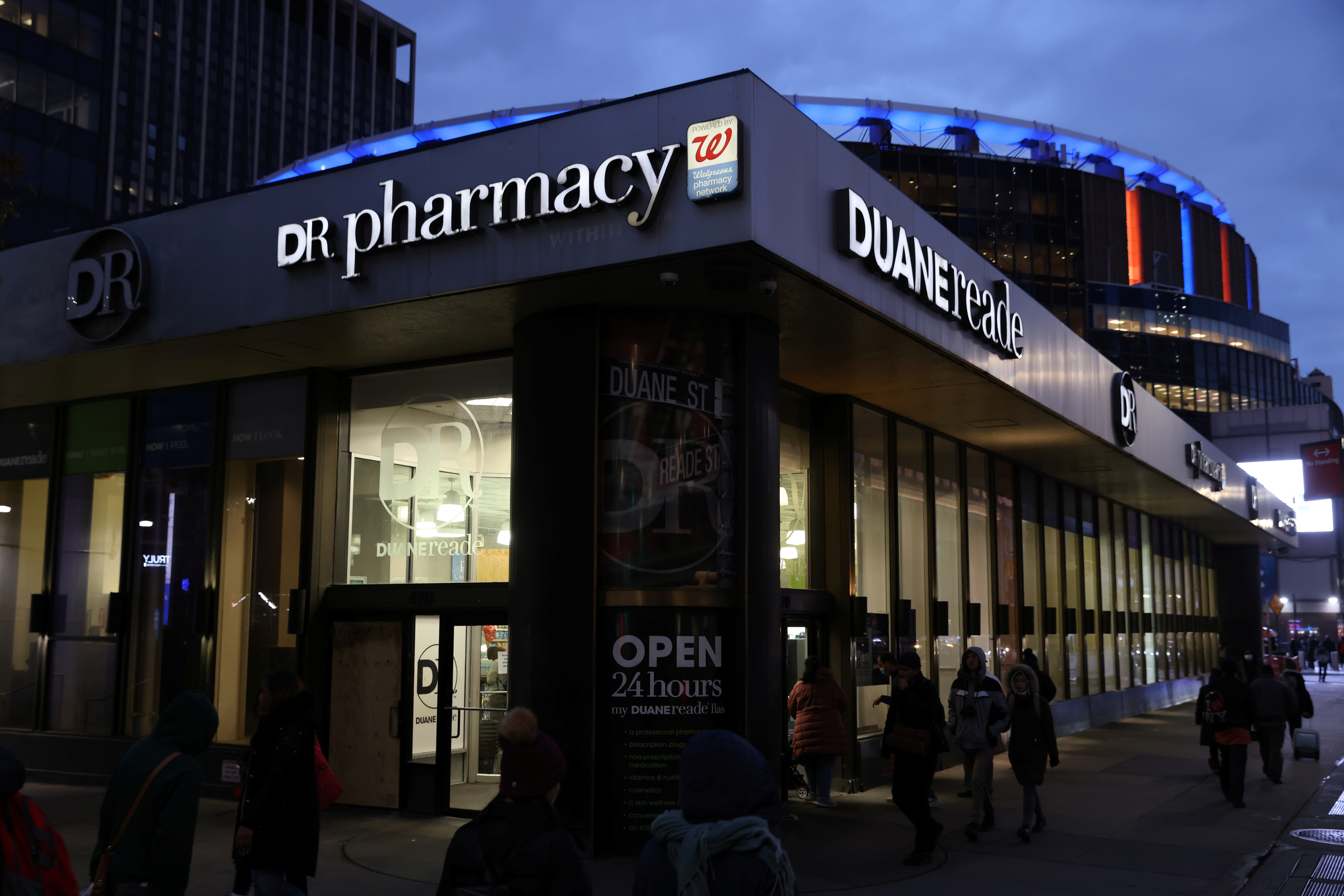 People walk by a Duane Reade pharmacy, owned by the Walgreens Boots Alliance, Inc., in Manhattan, New York City