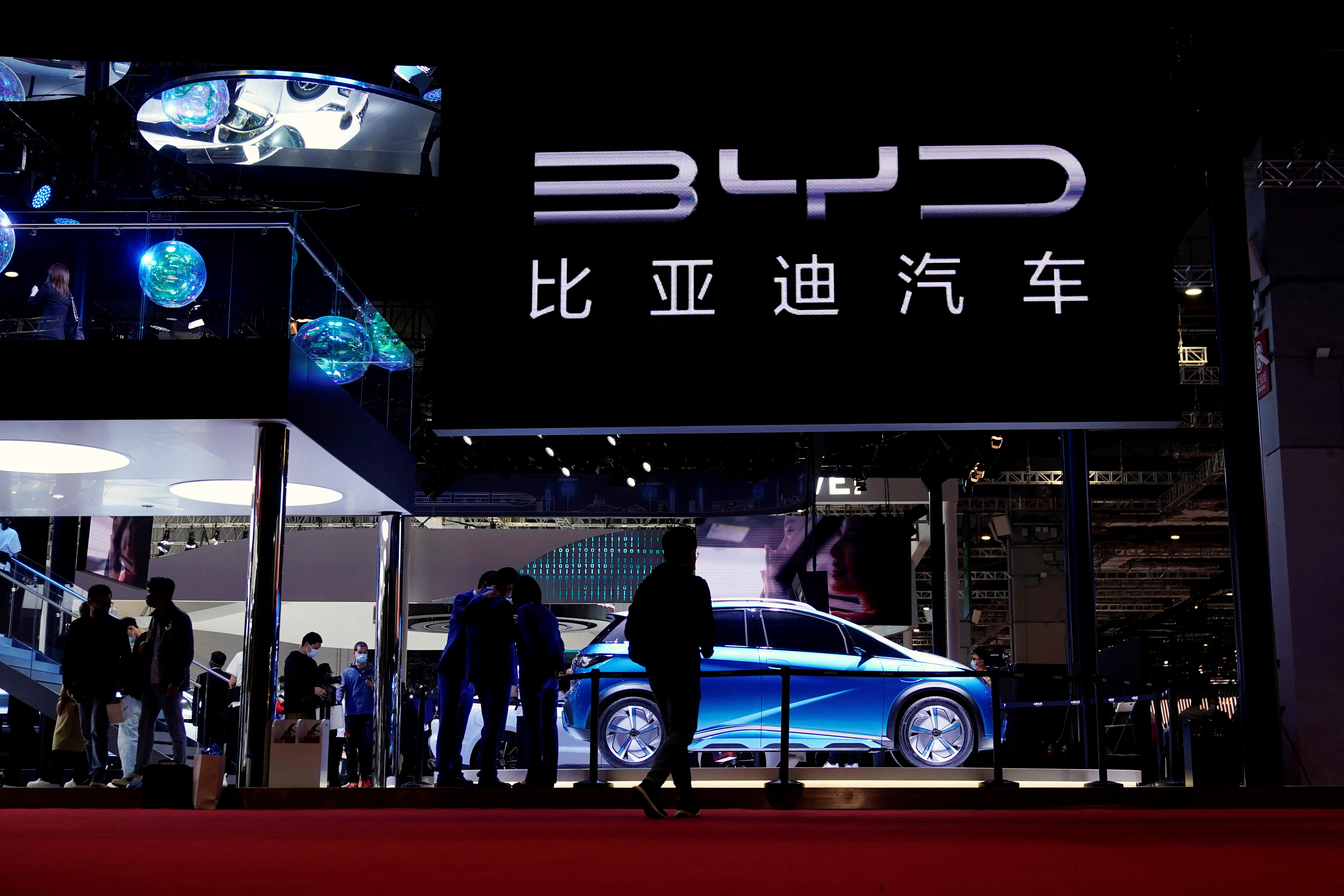 People visit the BYD booth during a media day for the Auto Shanghai show