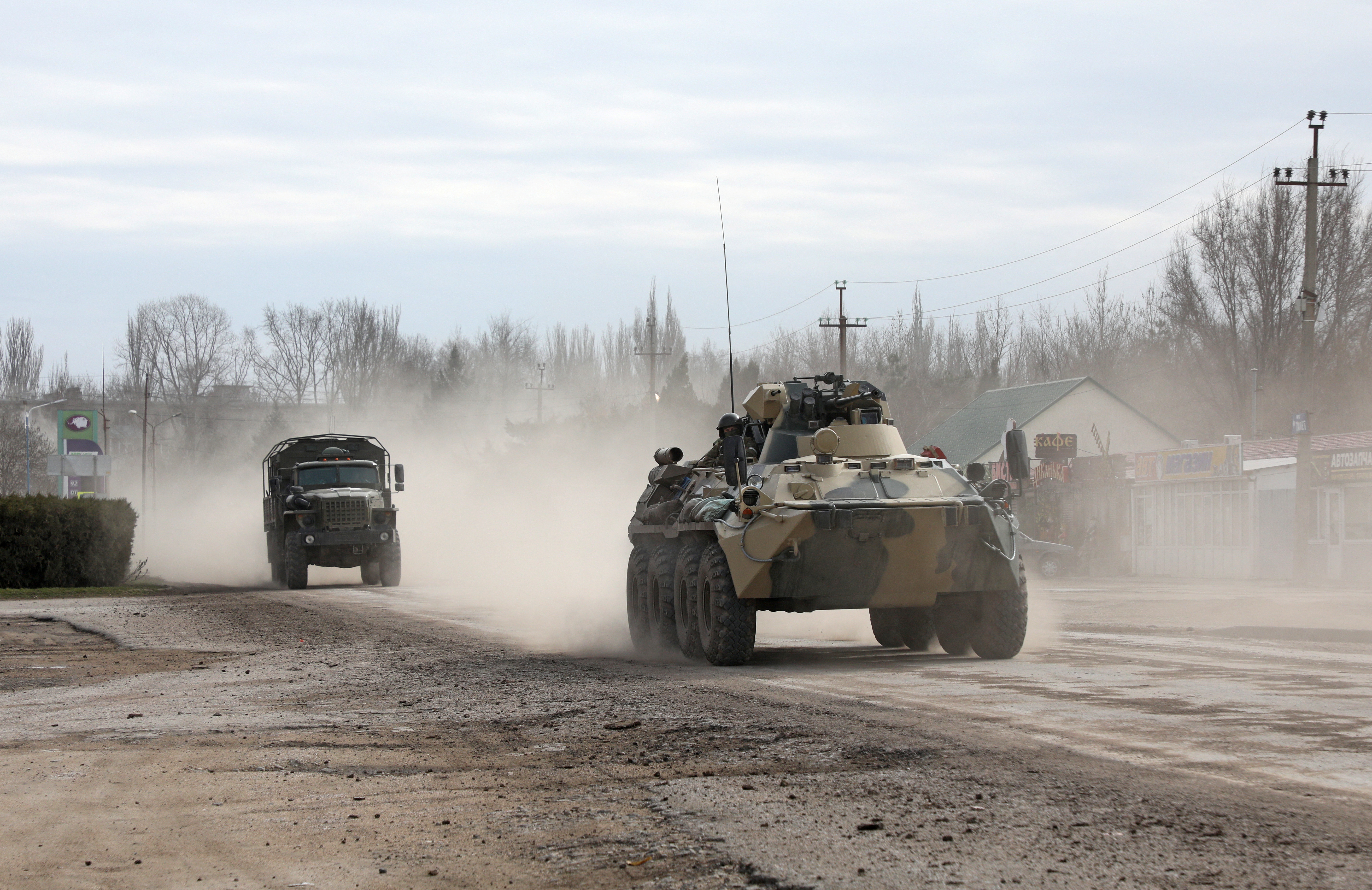 Russian Army military vehicles drive along a street in Armyansk