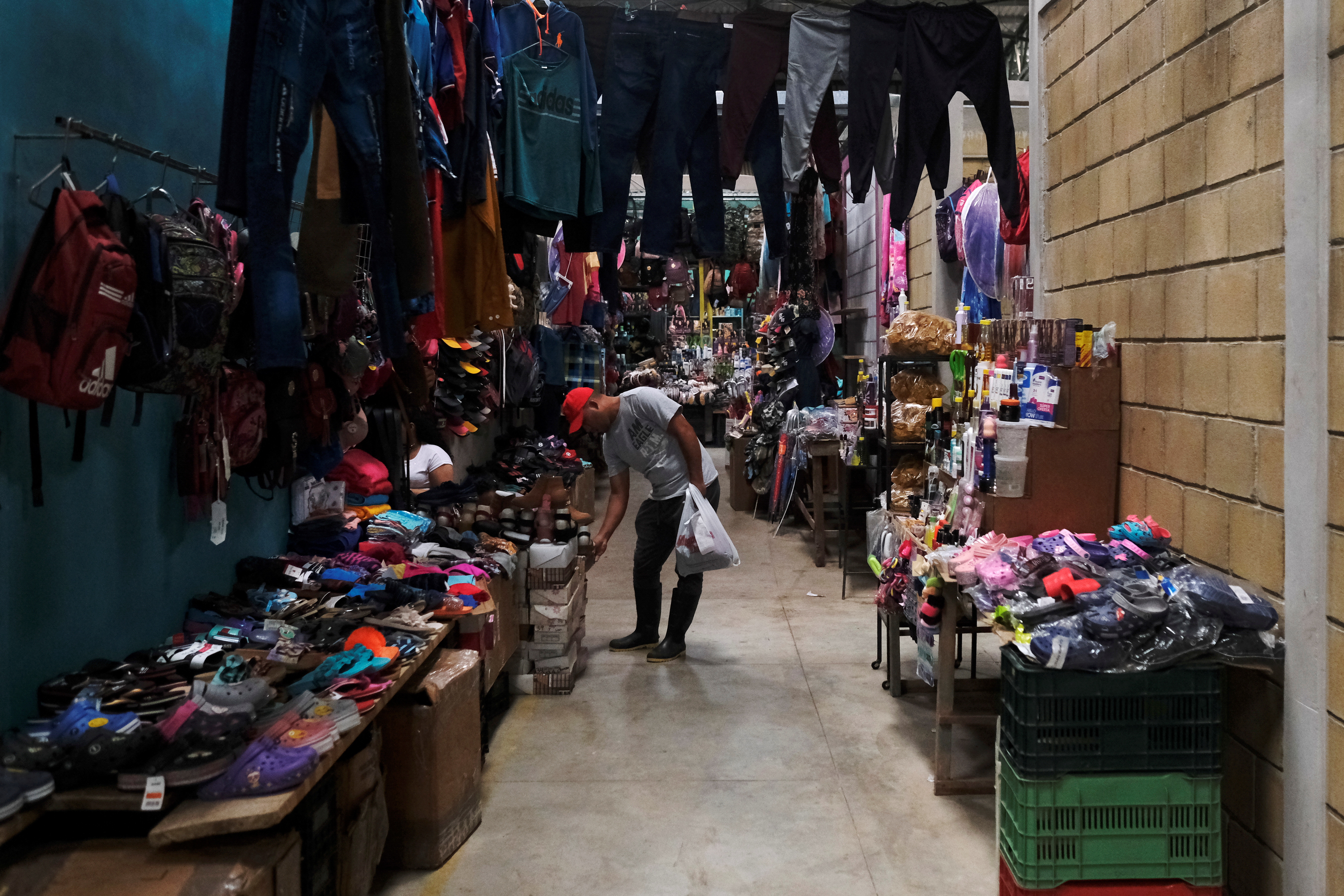 A man checks products in a market, prior to the November 28 general election, in Catacamas