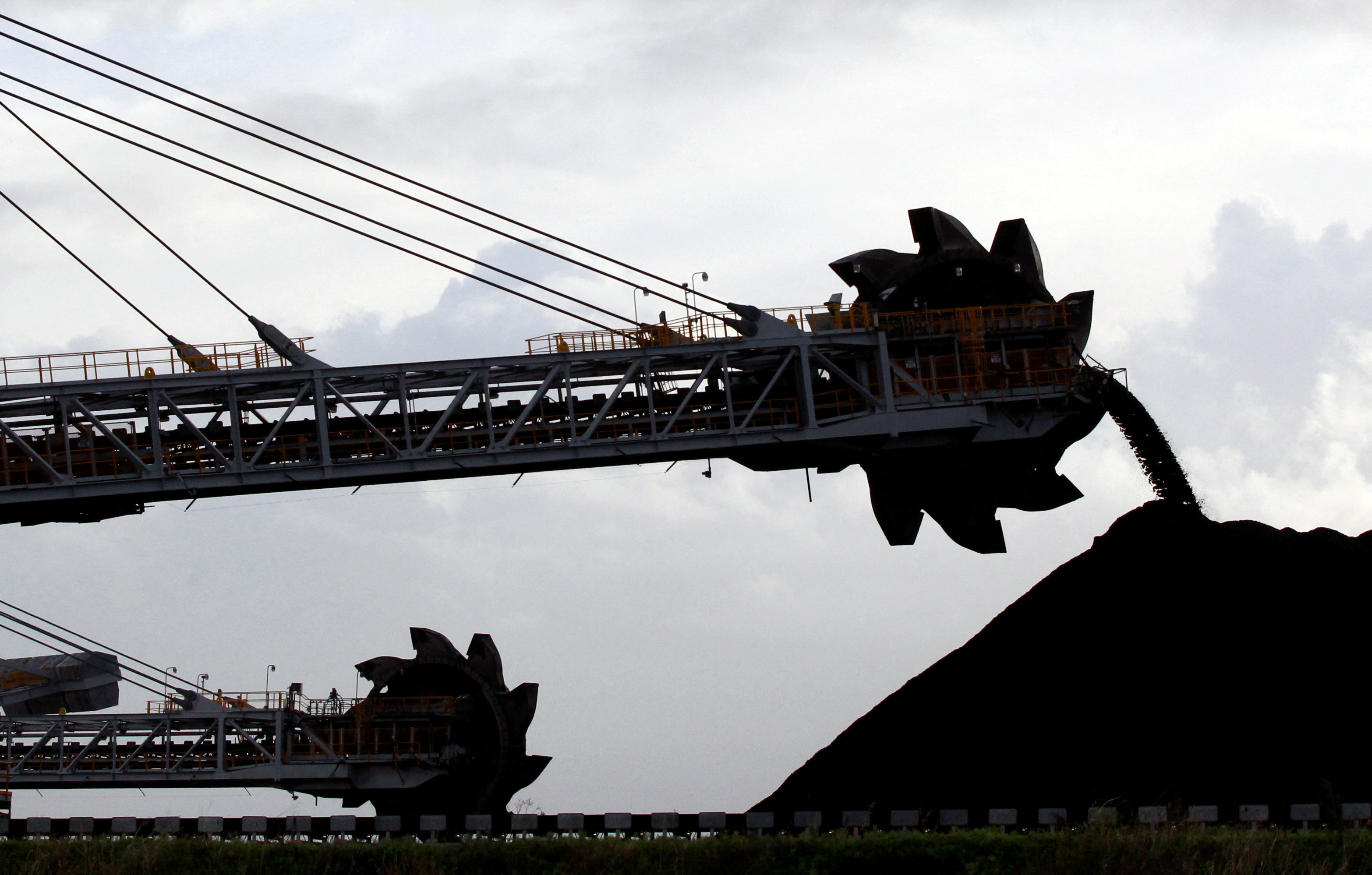 A stacker/reclaimer places coal in stockpiles at the port in Newcastle, Australia