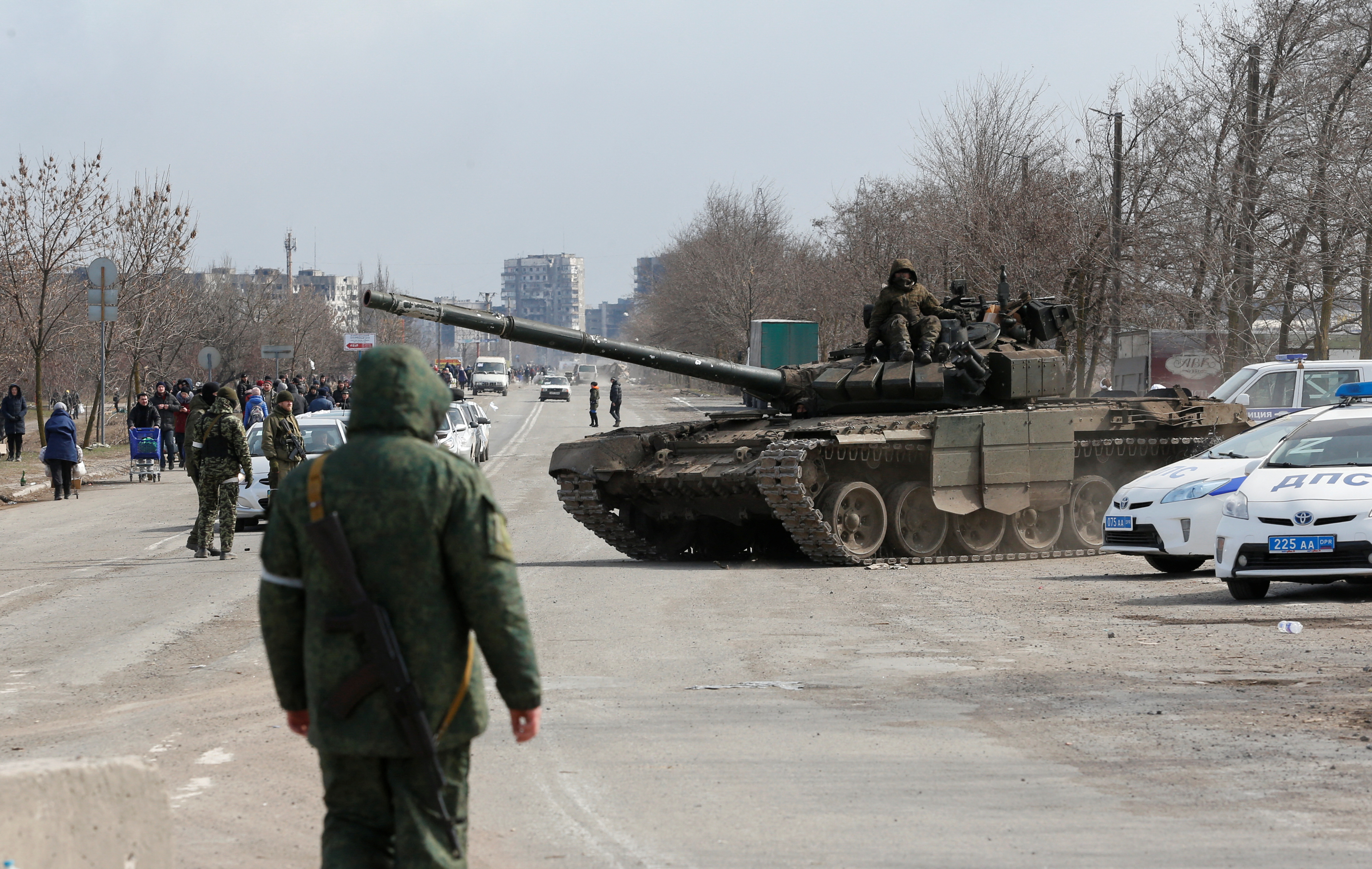 Service members of pro-Russian troops are seen in the besieged city of Mariupol
