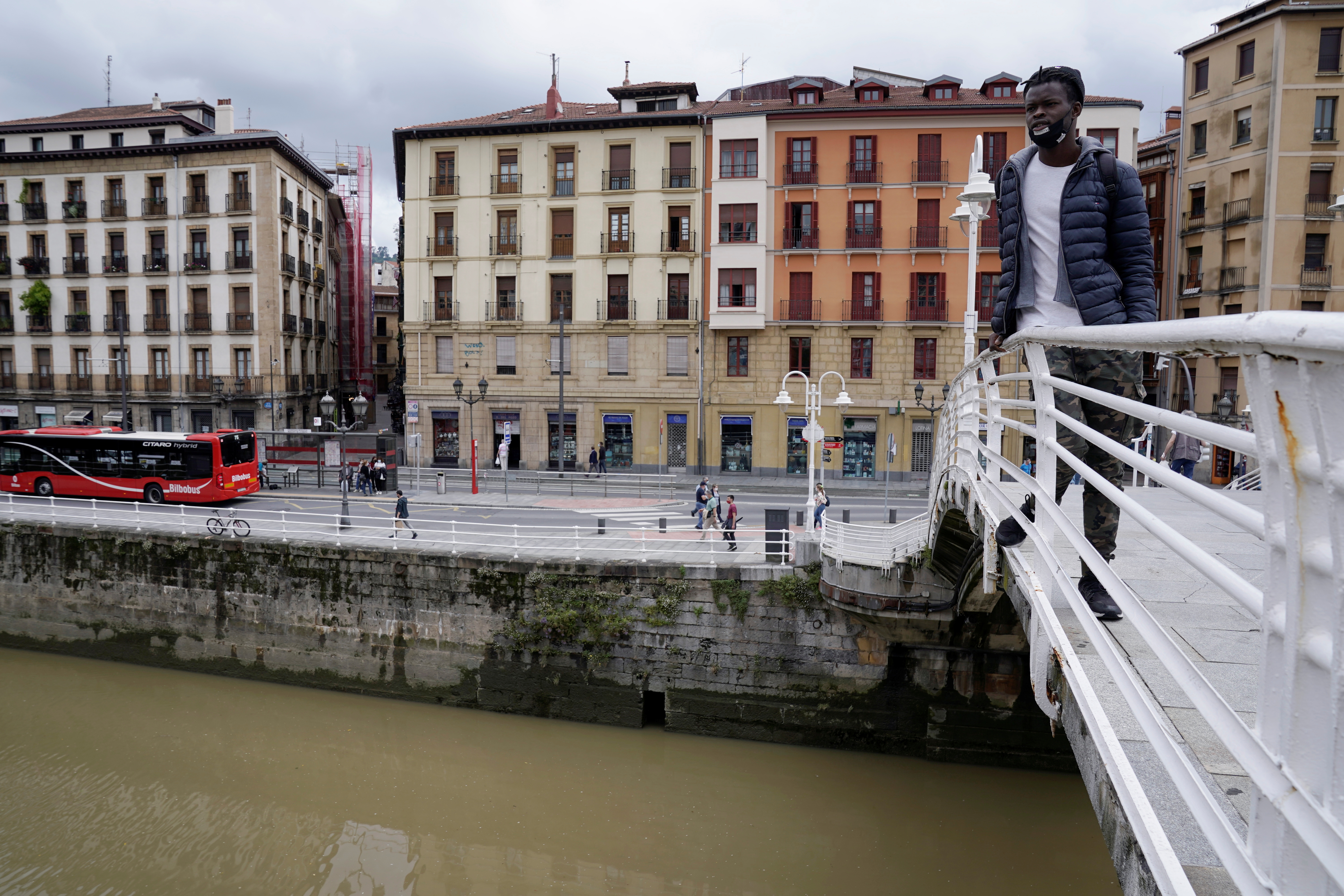 Mohamed Fadal Diouf, 26, from Senegal, stands on a pedestrian bridge over the river Nervion in Bilbao