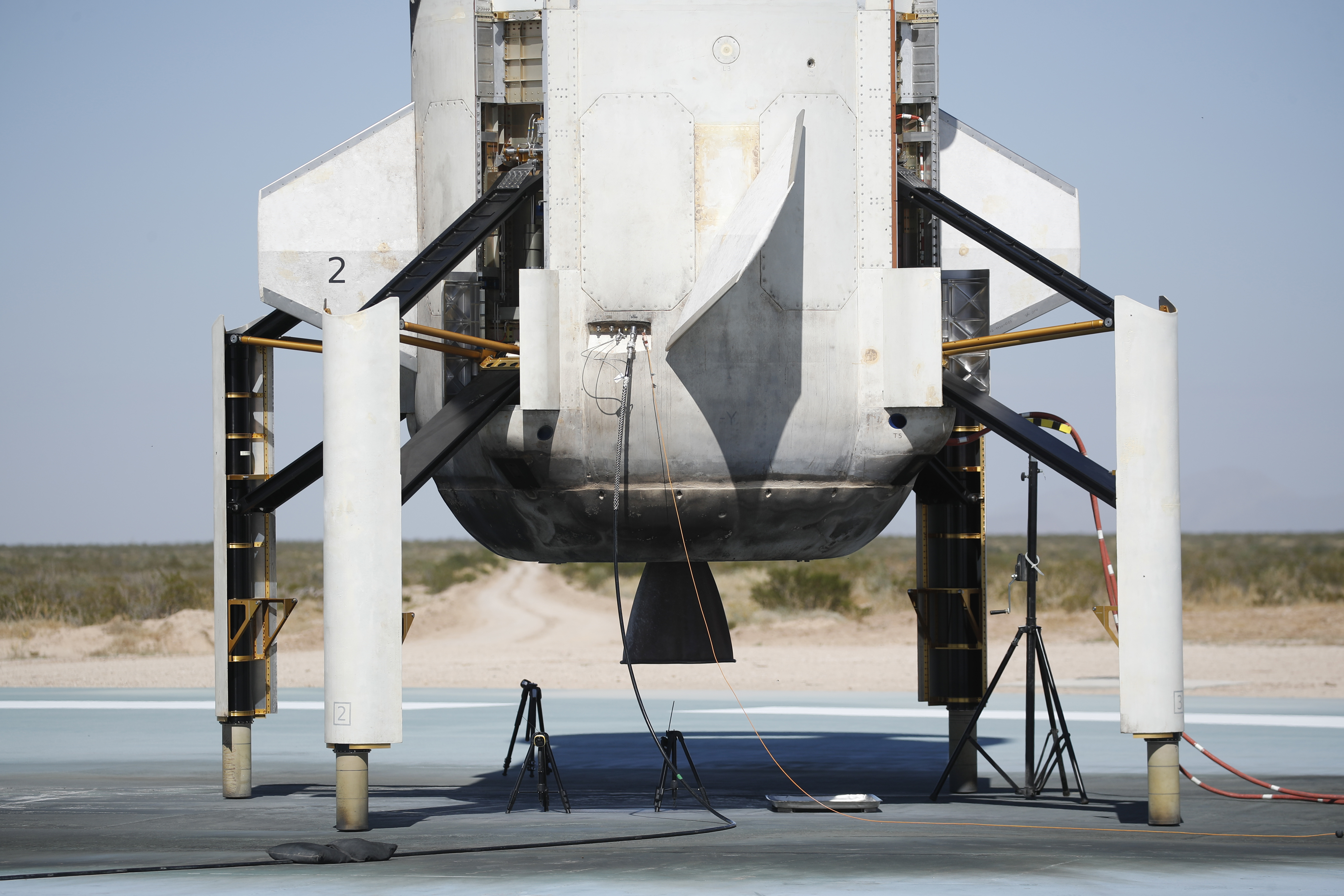 Blue Origin's reusable rocket engine New Shepard is seen on a landing pad after flight