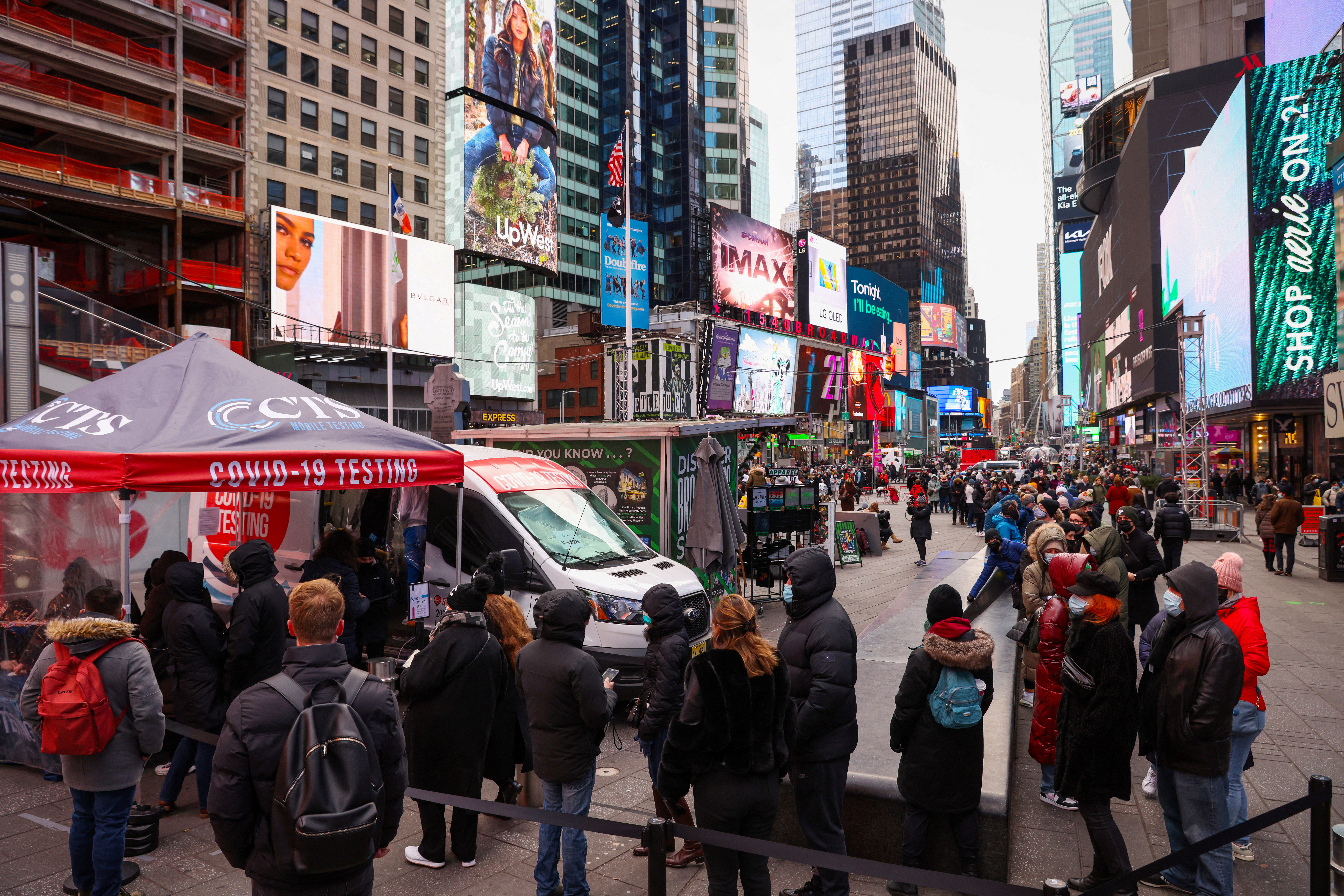 People stand in a queue for a coronavirus disease (COVID-19) test in Times Square as the Omicron coronavirus variant continues to spread in Manhattan, New York City
