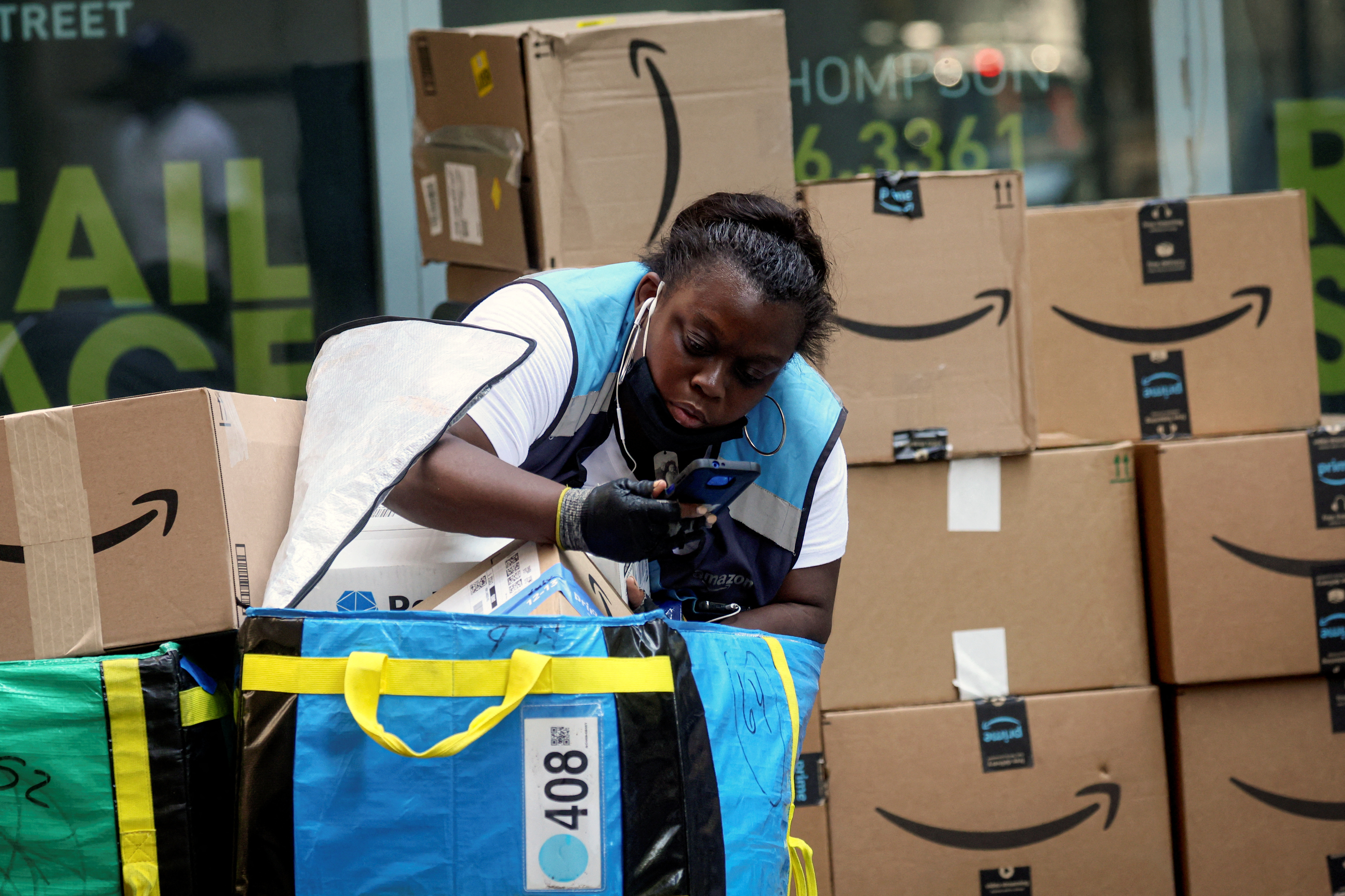 An Amazon delivery worker checks packages in New York