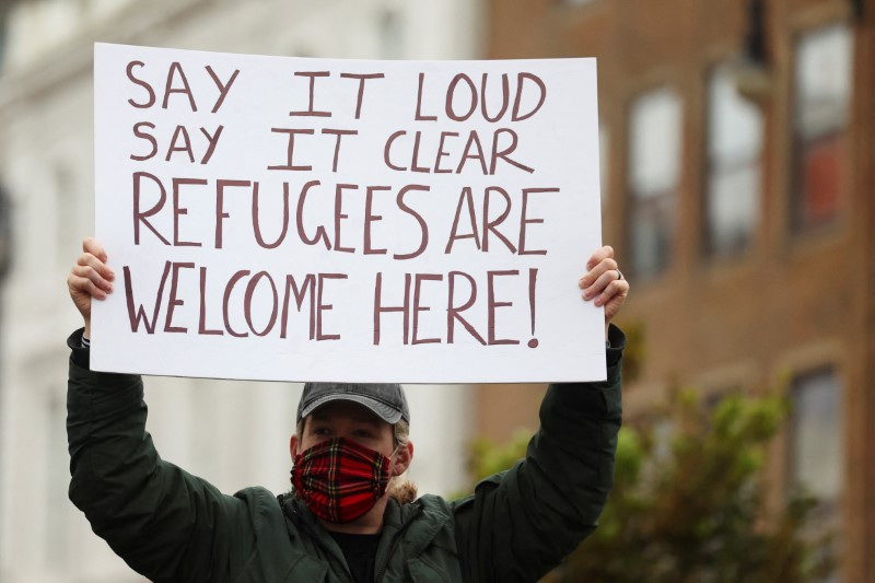 People gather to demonstrate against recent anti-immigration protests, in Brighton