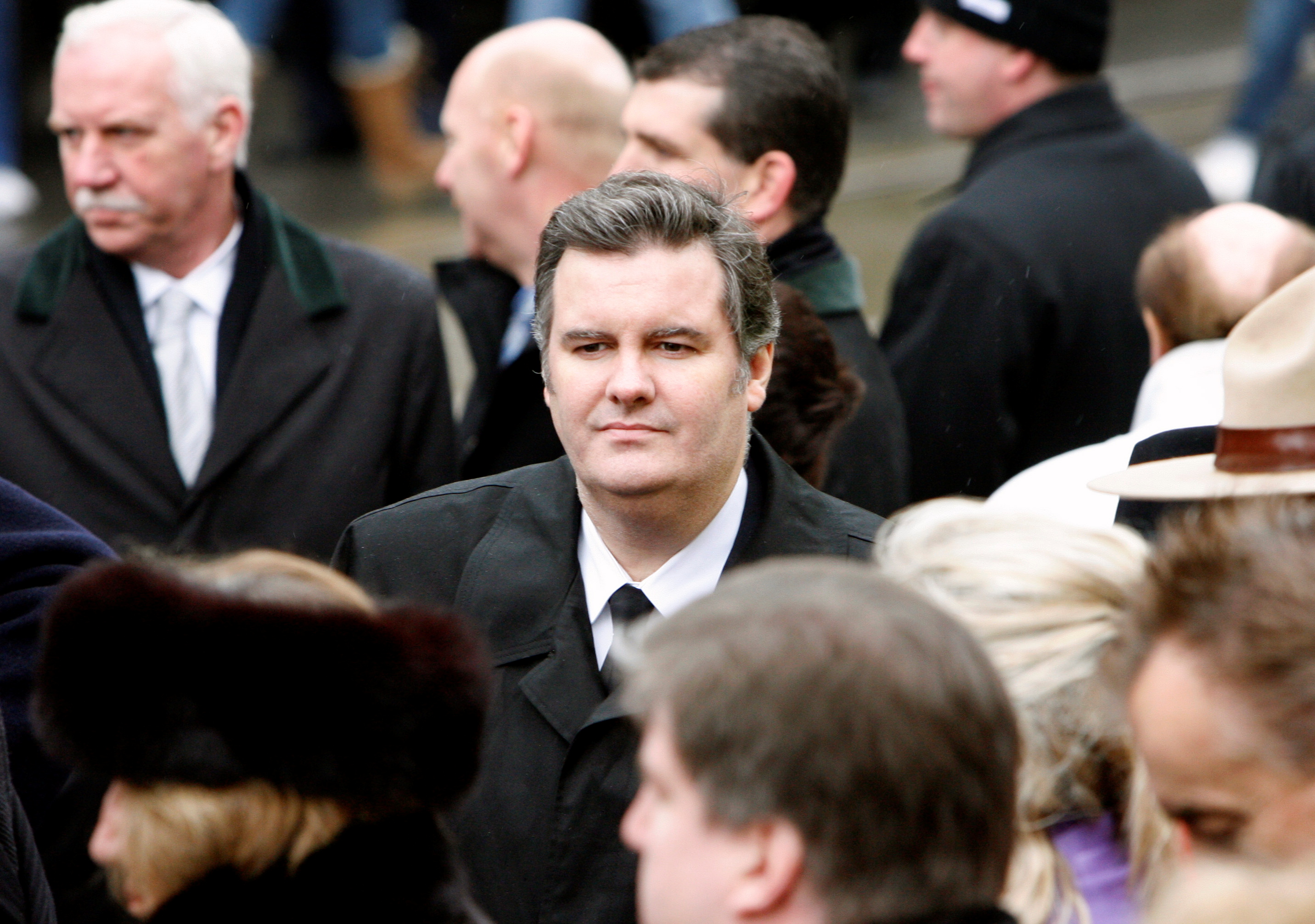 Edward Rogers stands with mourners at the funeral for his father Ted Rogers, president and CEO of Rogers Communications, in Toronto