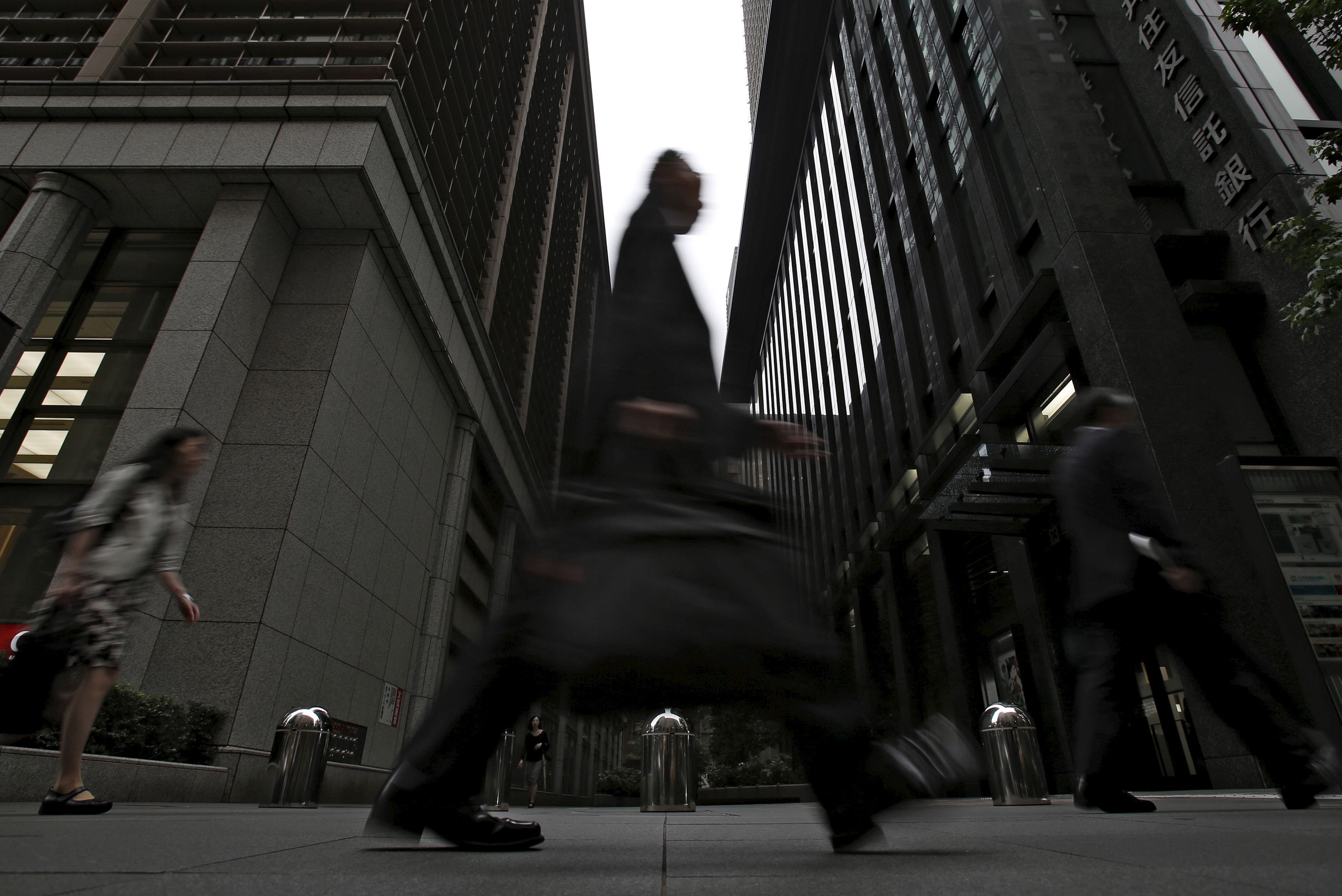 A man walks on a street at a business district in Tokyo