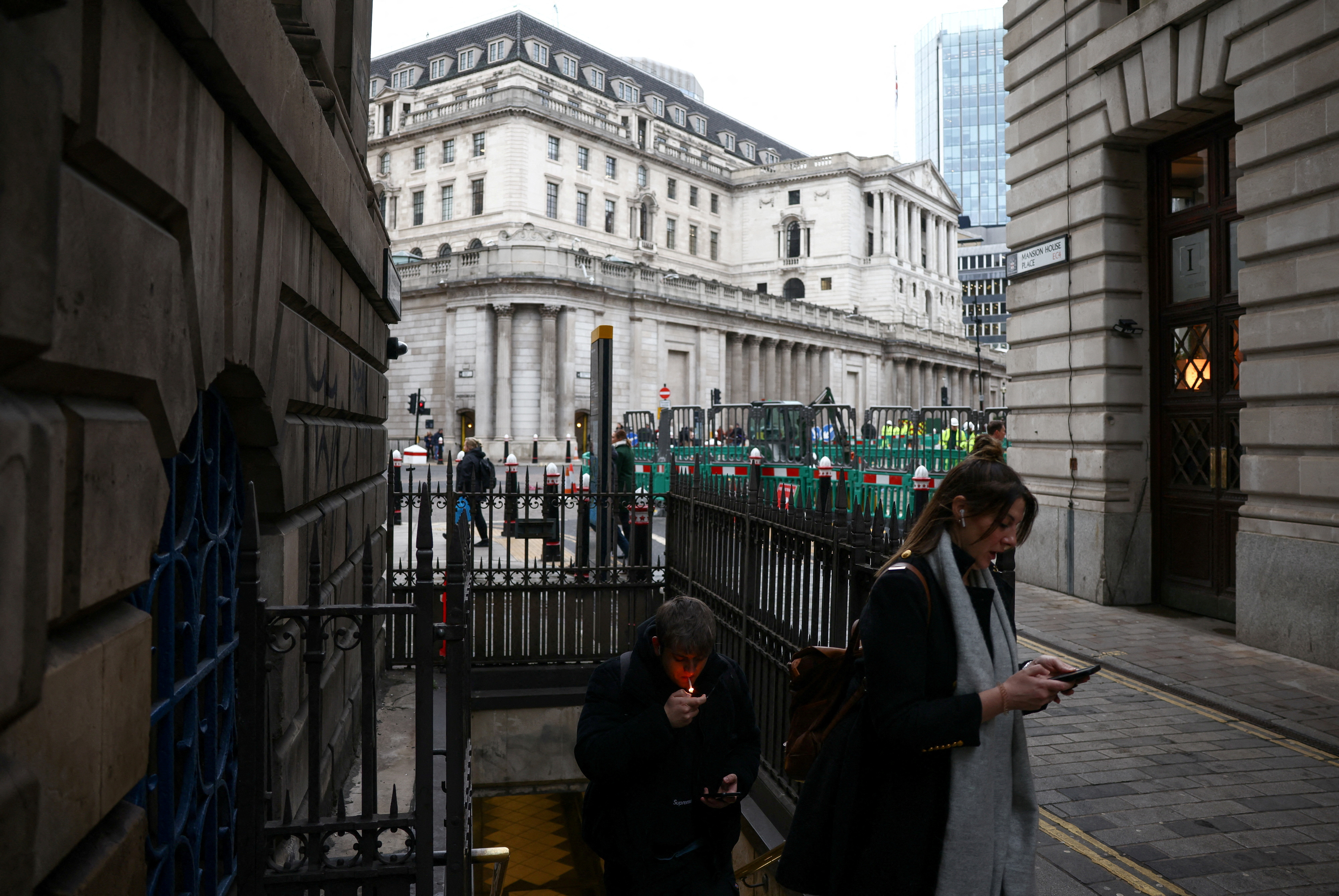 People exit Bank underground station outside the Bank of England in the City of London financial district
