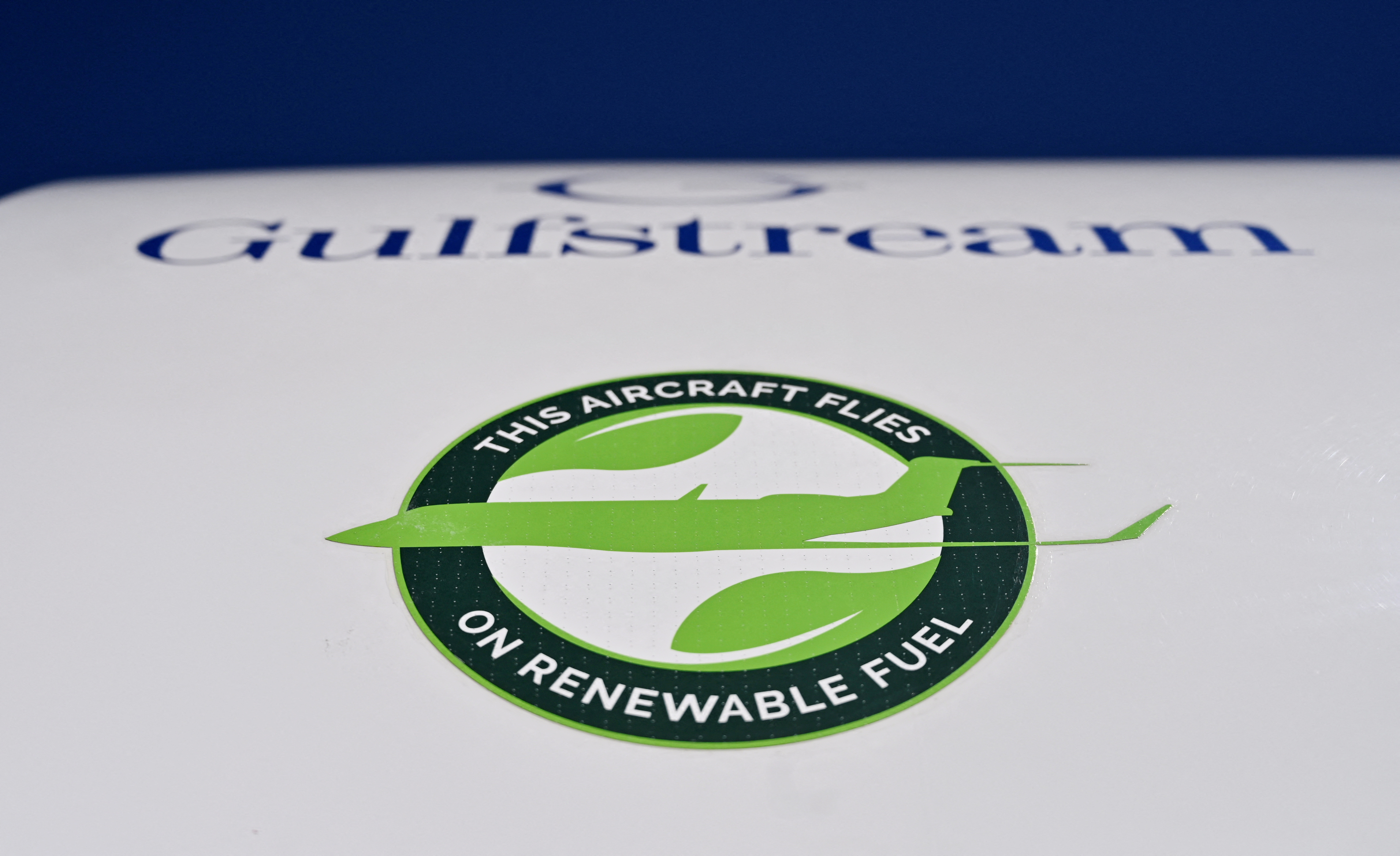 A sticker reading "This plane flies on renewable fuel" is seen on a Gulfstream 650ER business jet at the National Business Aviation Association (NBAA) exhibit in Las Vegas